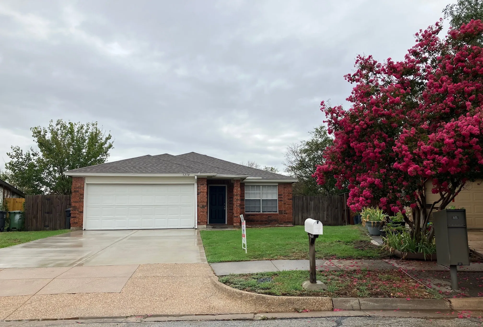 Brick exterior with a prominent two-car garage