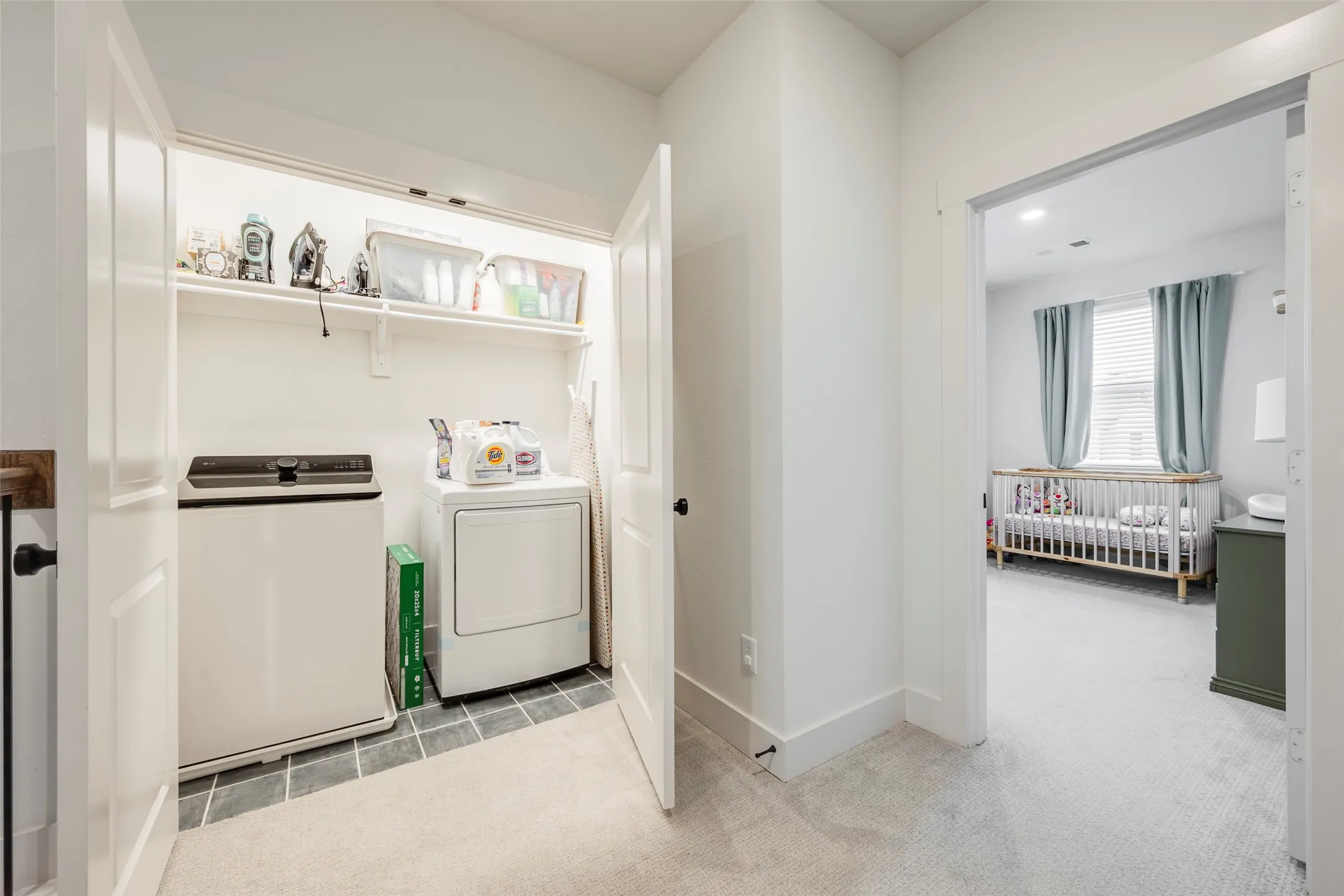 Dedicated laundry closet with tile flooring