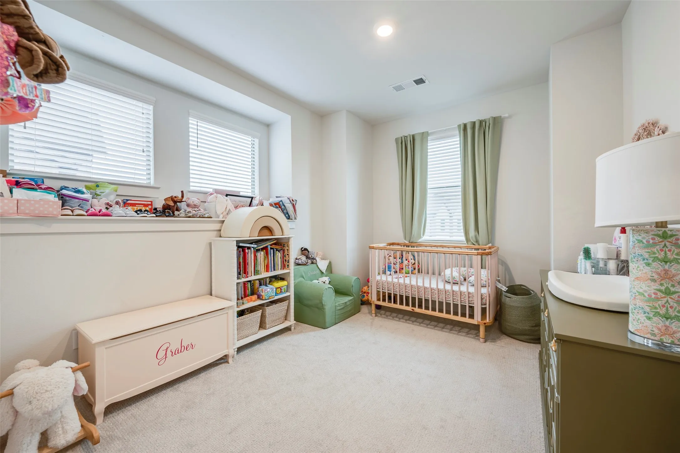 Recessed lighting, light-toned carpet, and multiple windows with blinds