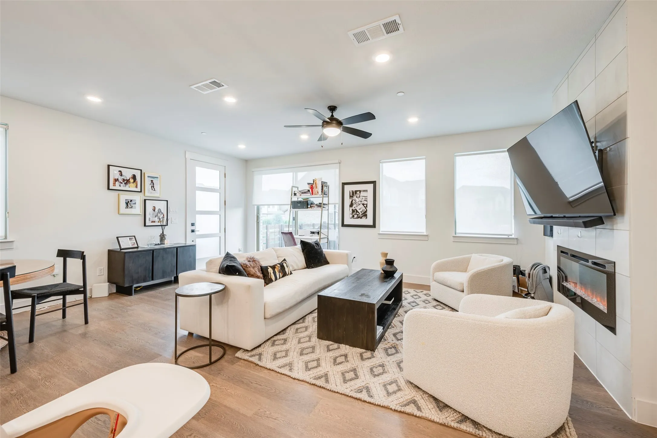 Expansive living space featuring wood-finish flooring, recessed lighting, and a ceiling fan