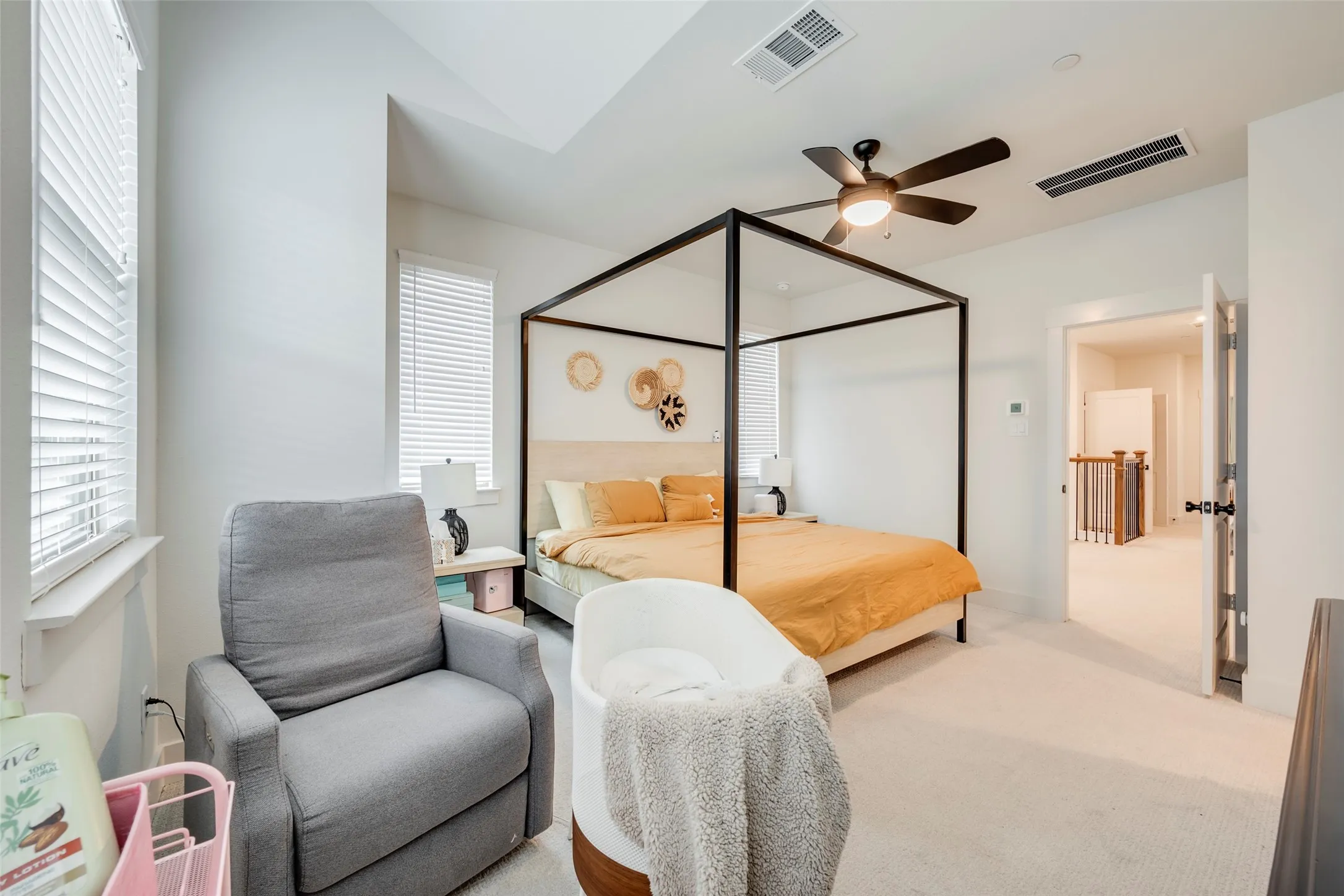 Recessed lighting, ceiling fan, carpeting, and multiple windows with blinds