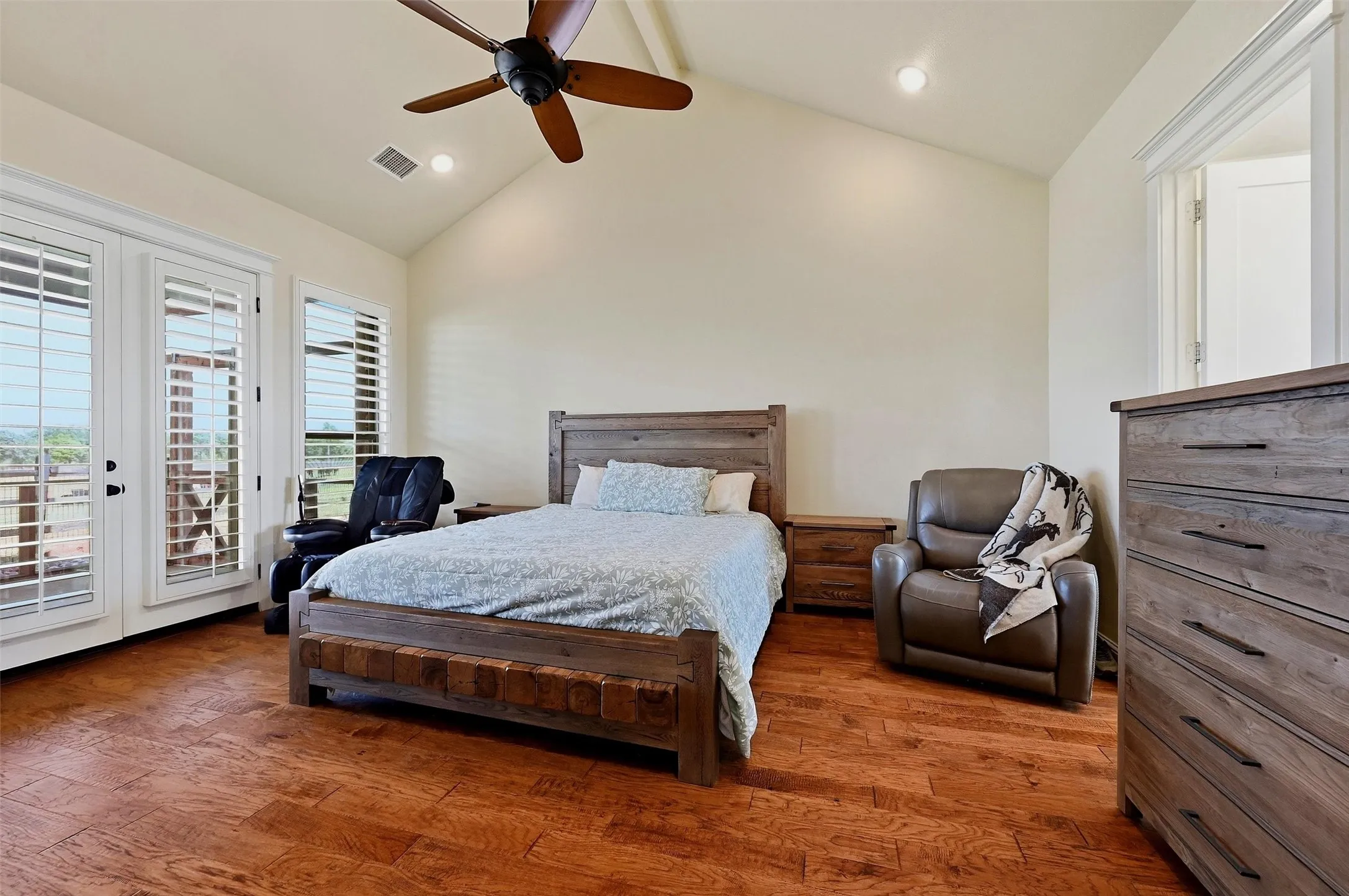 Primary bedroom with french doors to the back porch.