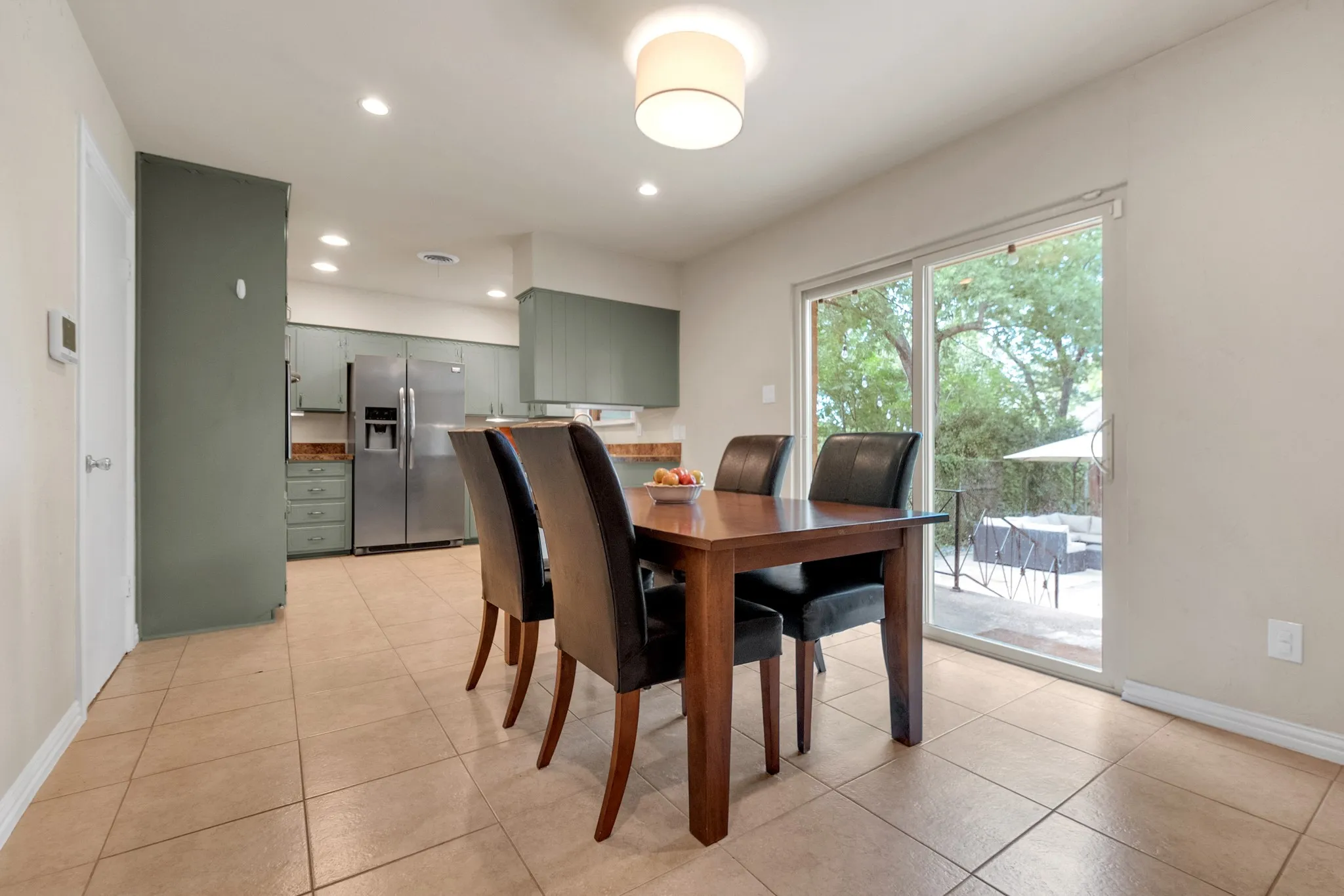 Dining area featuring tile flooring and a contemporary ceiling light fixture