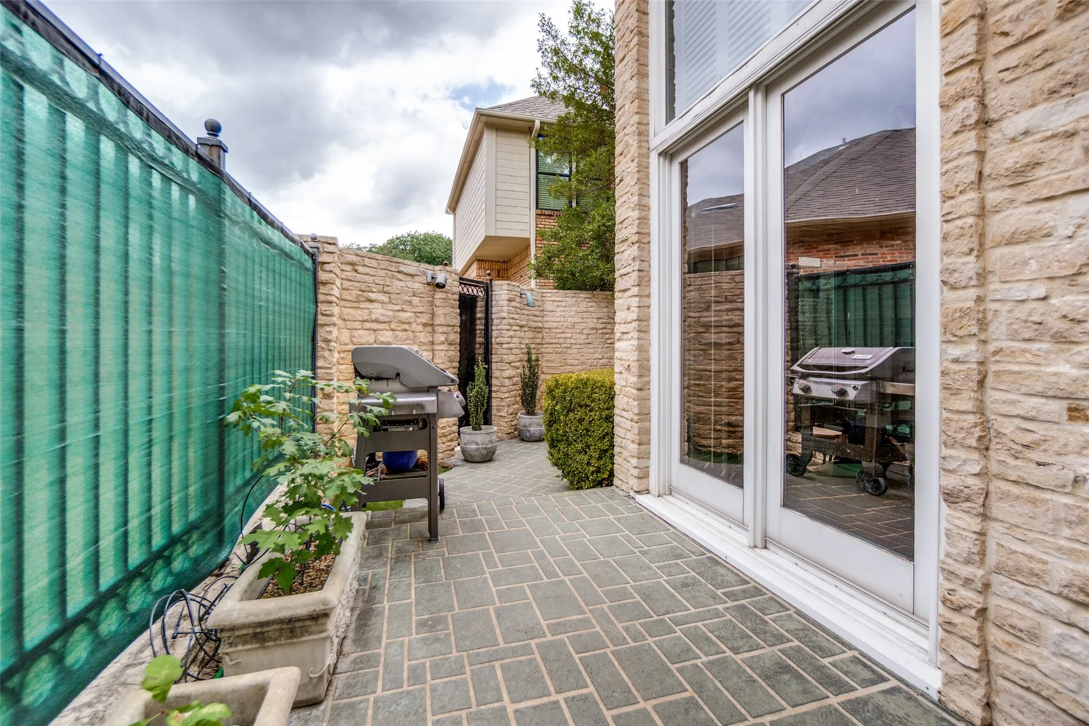 Paved patio area with stone-finish walls