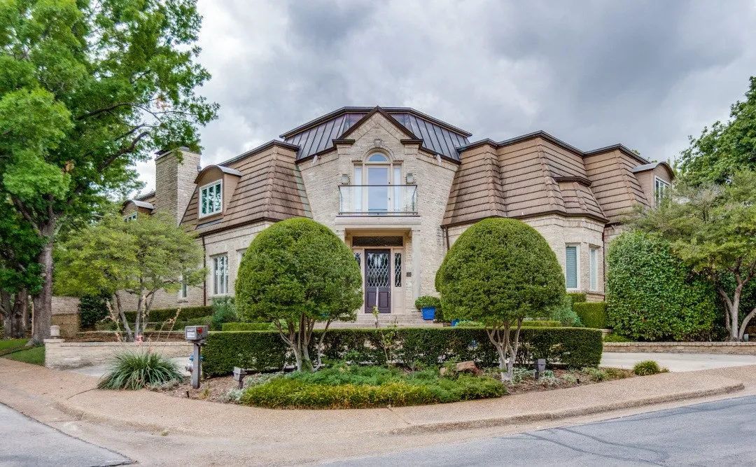 Stone veneer exterior with mansard roofing