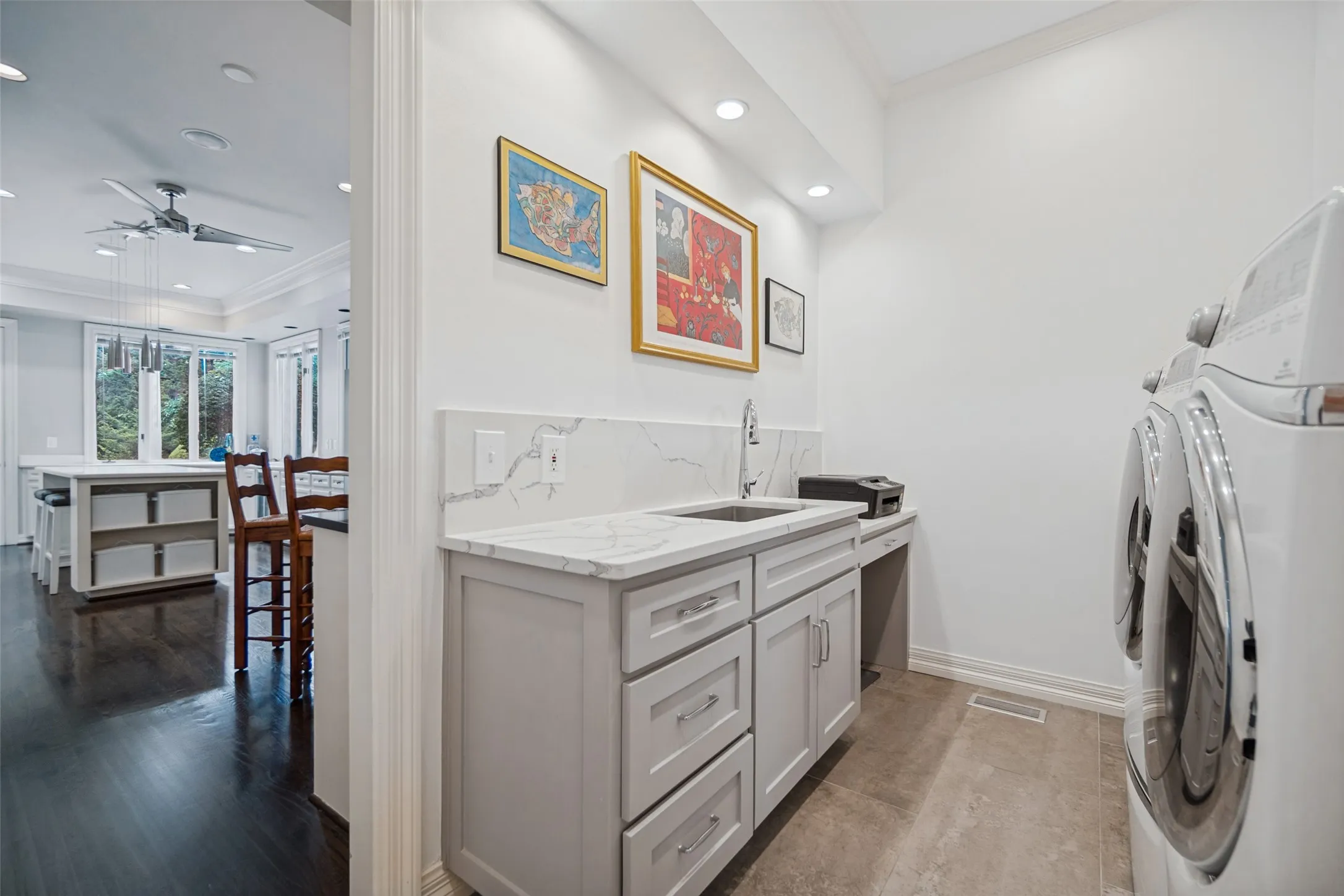 Laundry area featuring white walls, recessed lighting, and a utility sink