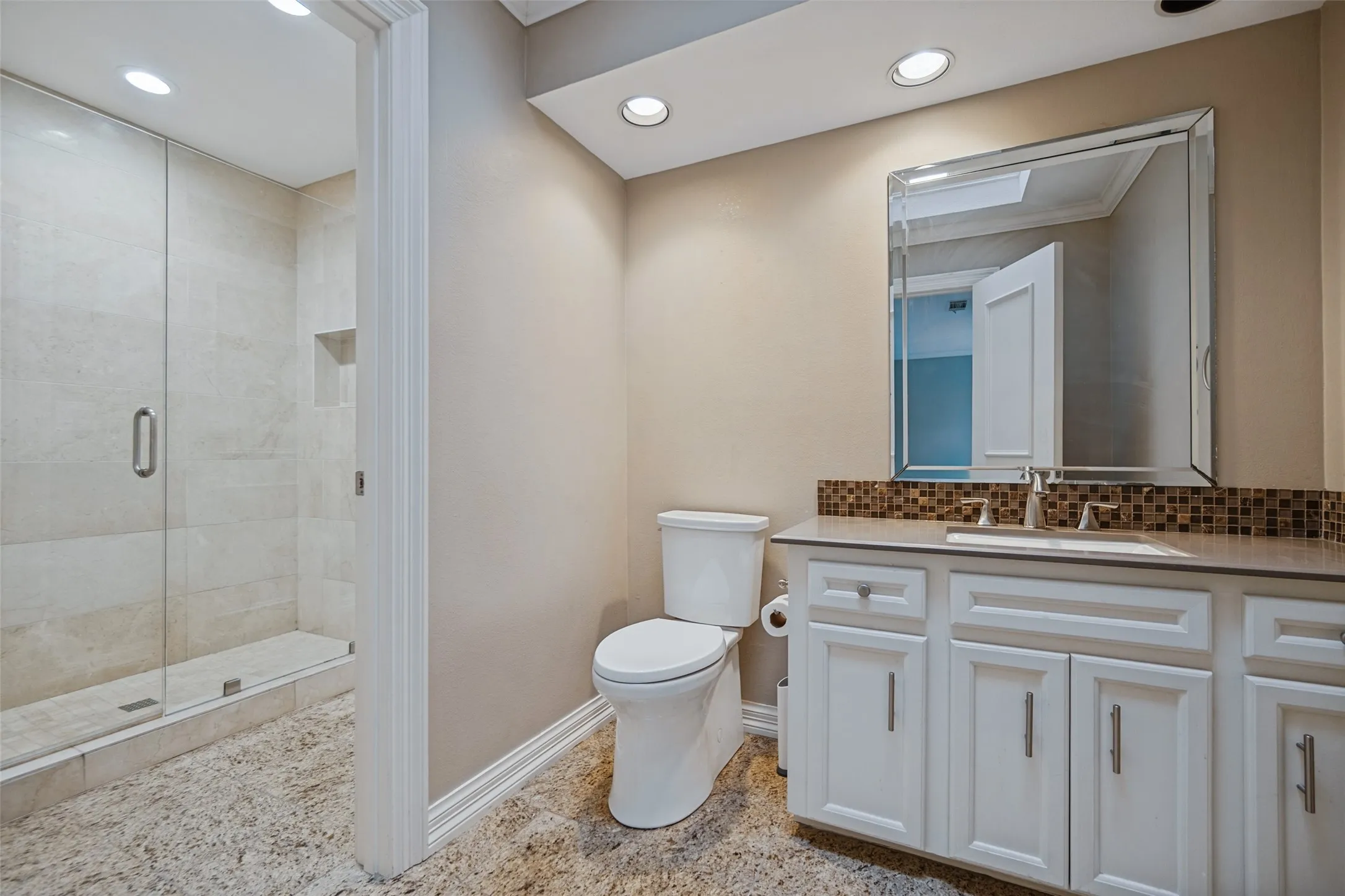Walk-in shower with clear glass enclosure