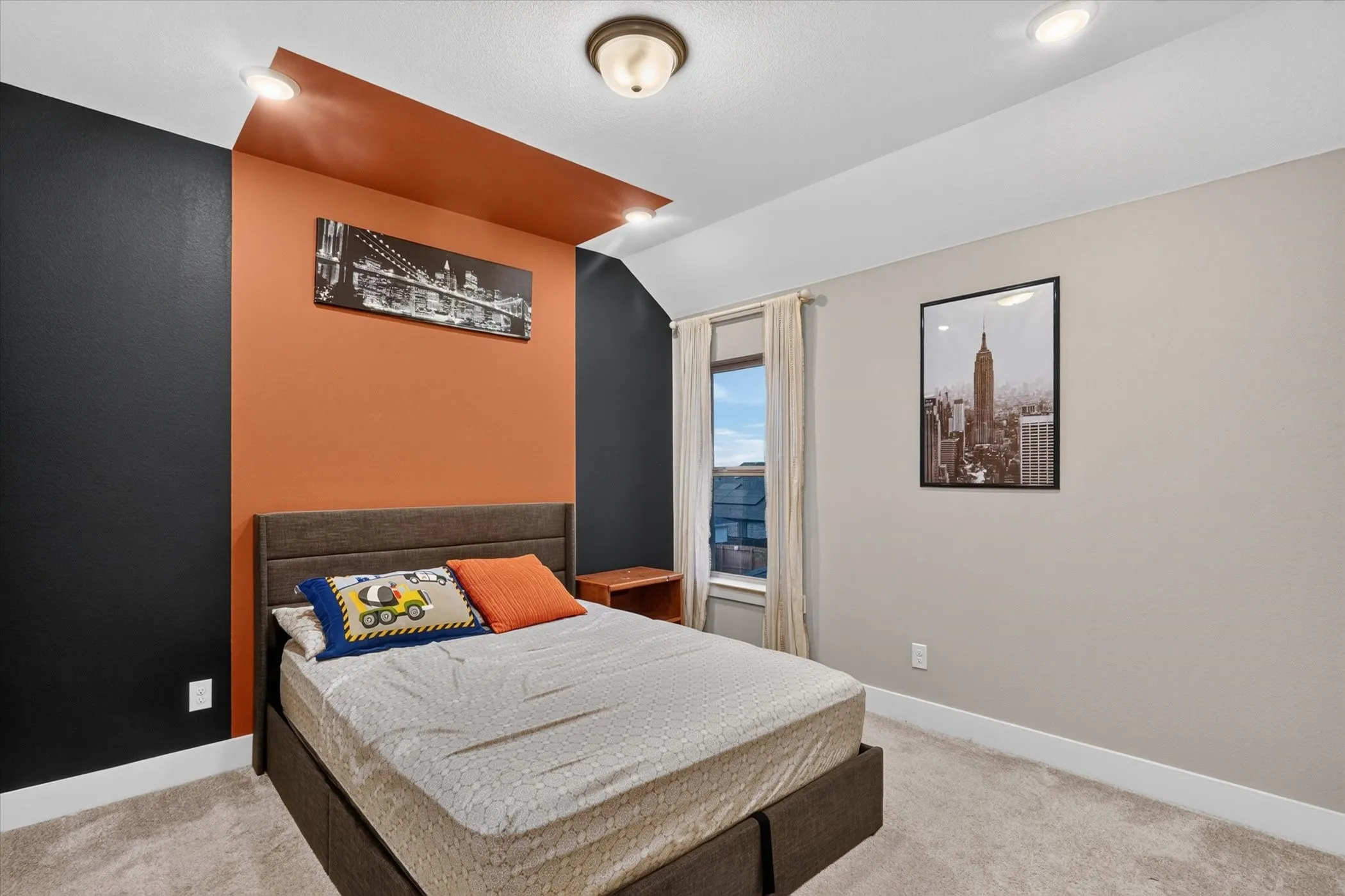 Recessed lighting and a central ceiling fixture illuminate the room