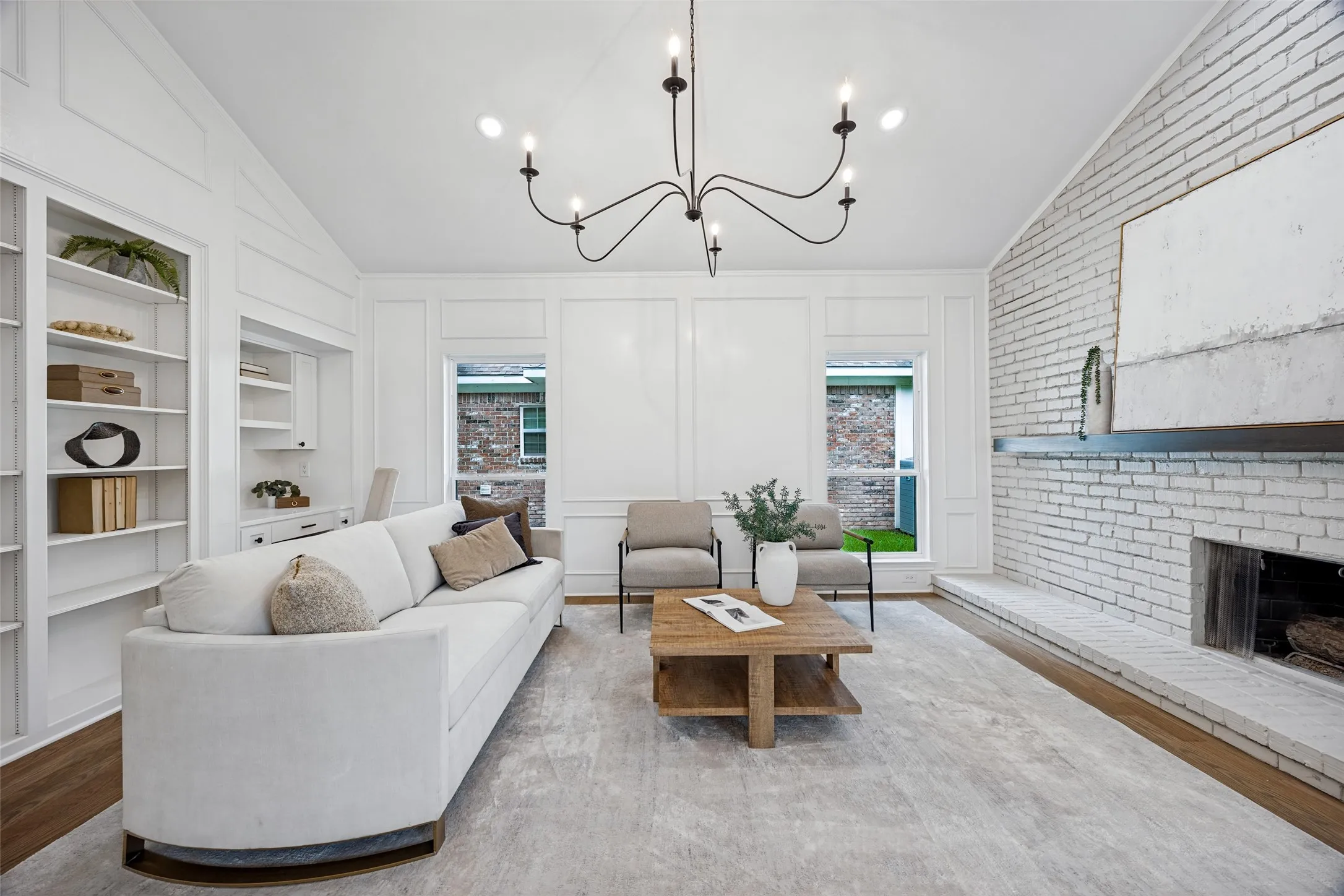 Second living room off kitchen, with gas fireplace and custom shelving