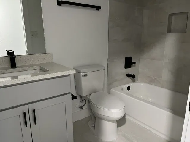 Vanity with a light-toned countertop and integrated sink