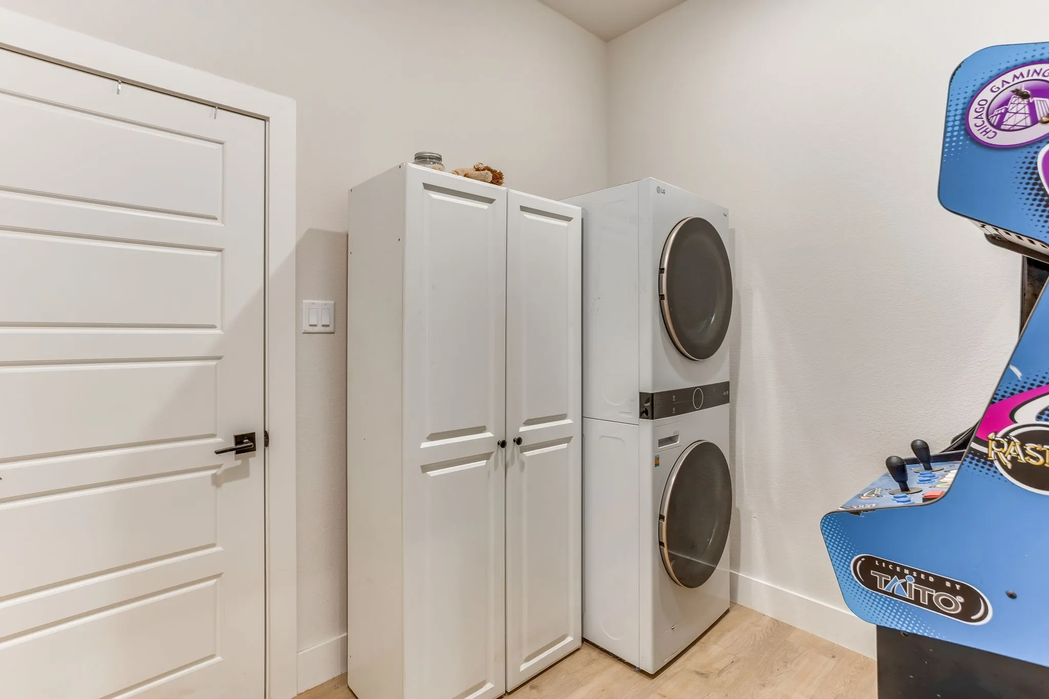 Laundry with door leading from primary closet