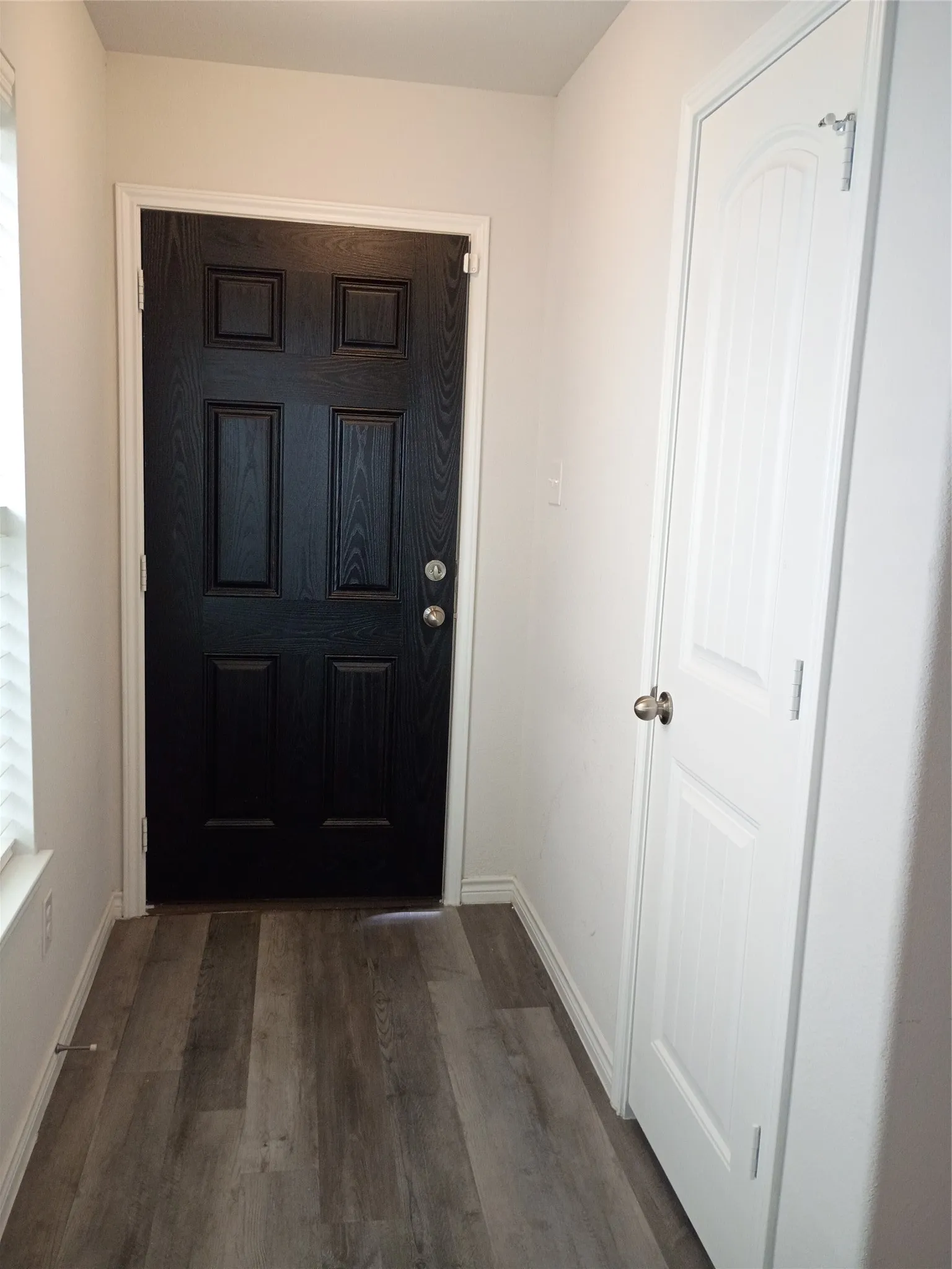 Foyer looking toward front door. Coat closet on the right