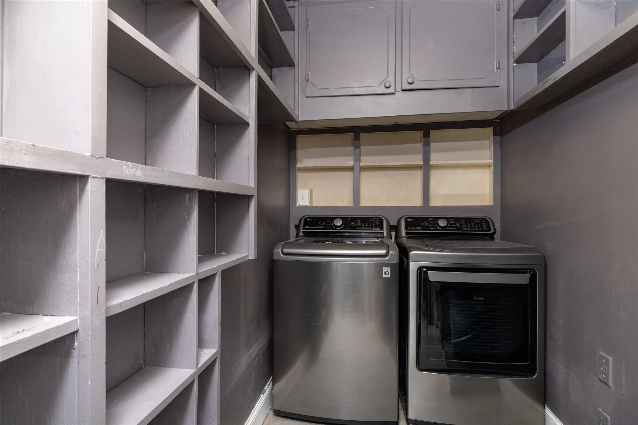 Built-in shelving, overhead cabinetry, and integrated appliances