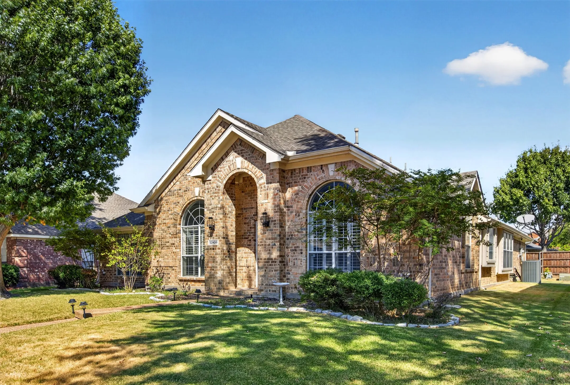 Brick exterior with an arched entryway and gabled roofline