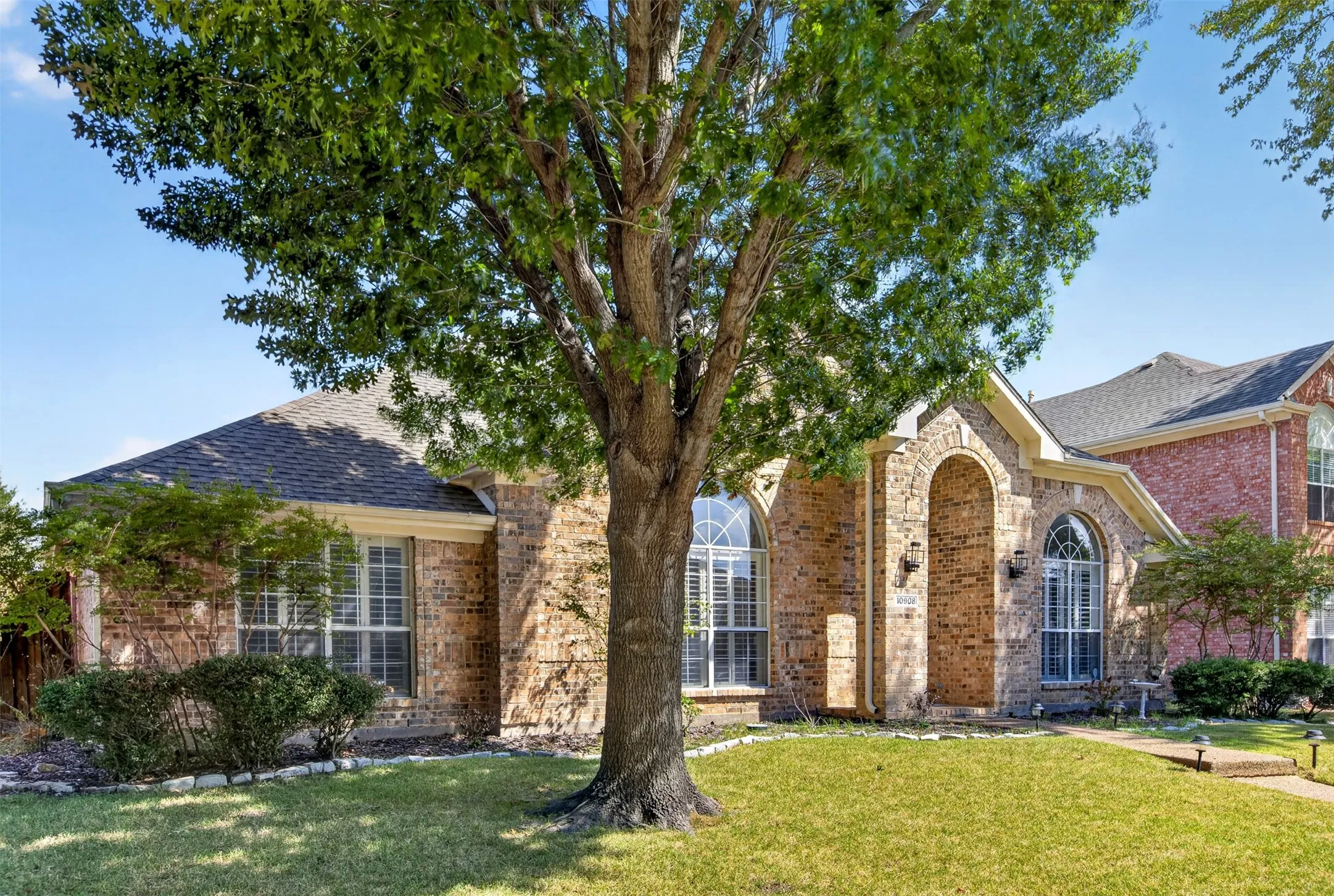 Brick exterior with arched entry, arched windows, and a gabled roof