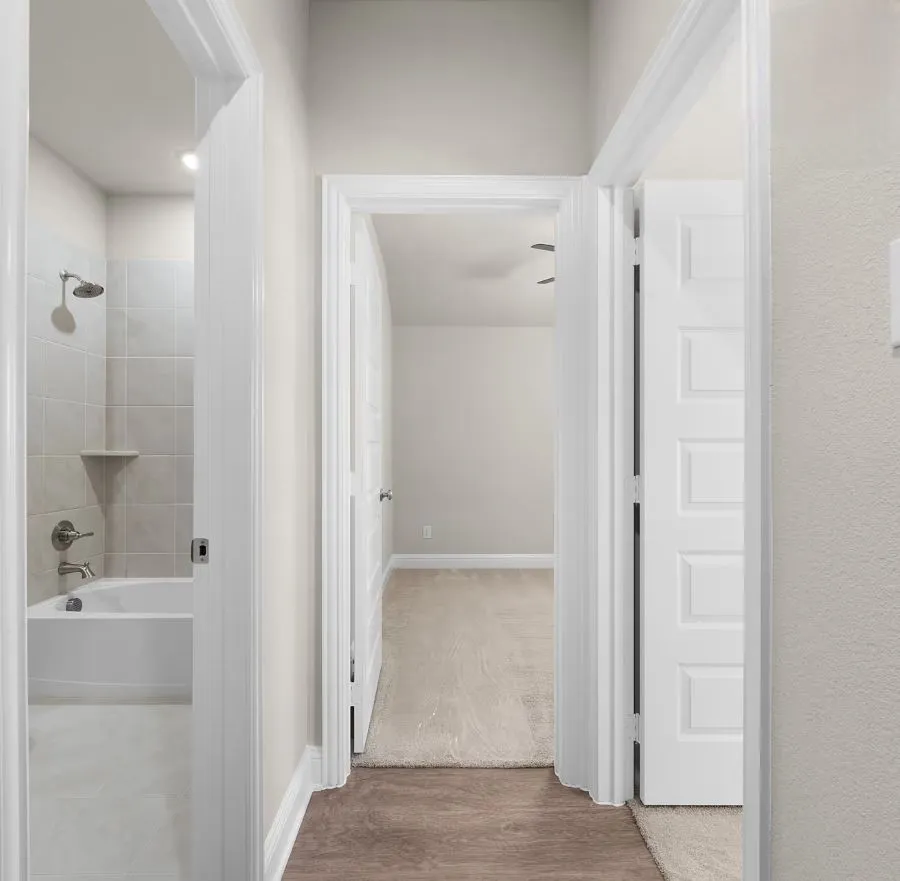 View of the hallway, 2nd bathroom and two bedrooms