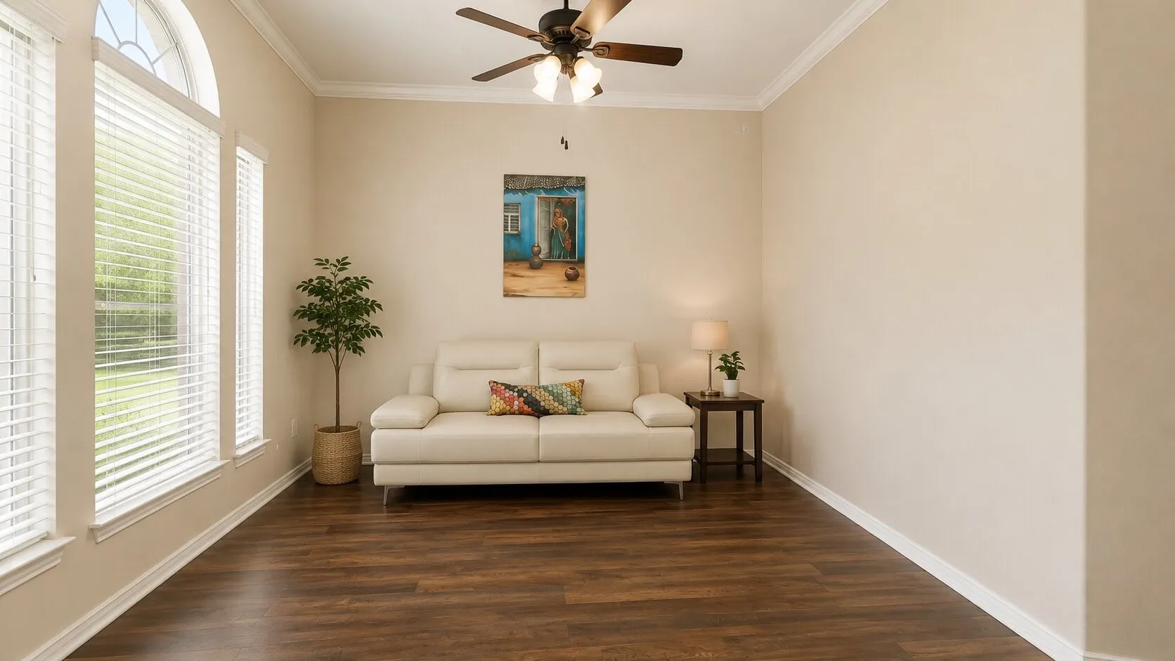 Wood-finish flooring, white window blinds, arched window, ceiling fan with integrated lighting, and crown molding