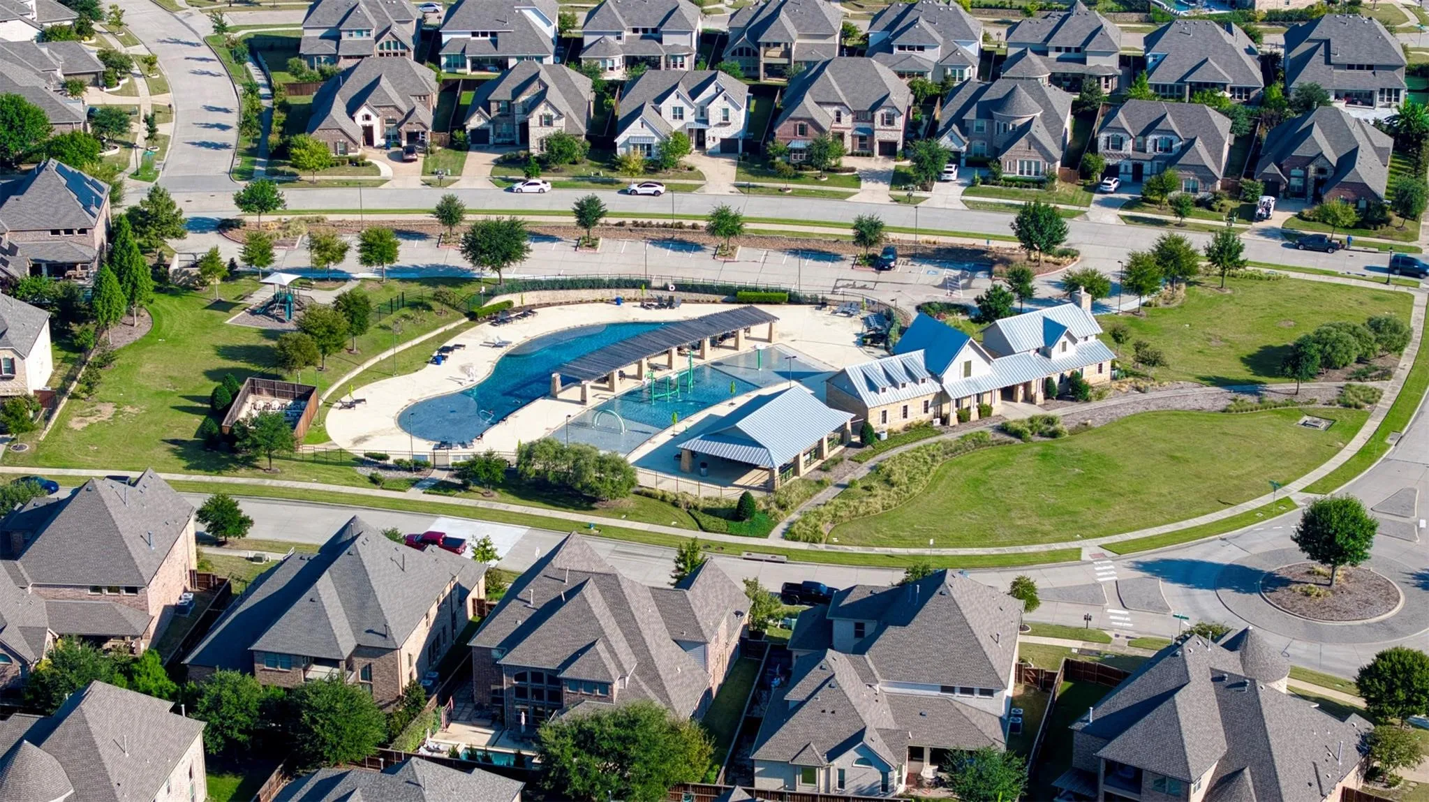 Community amenities featuring a swimming pool, covered lounge areas, and paved pathways