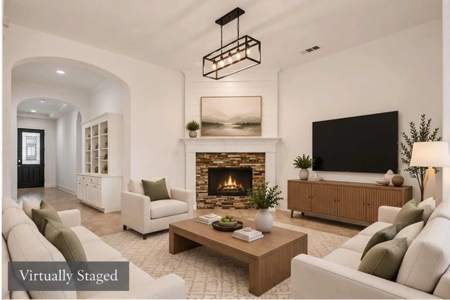 Arched entryway, built-in display cabinetry, stone-faced fireplace with white mantel, ceiling-mounted linear light fixture, and recessed lighting
