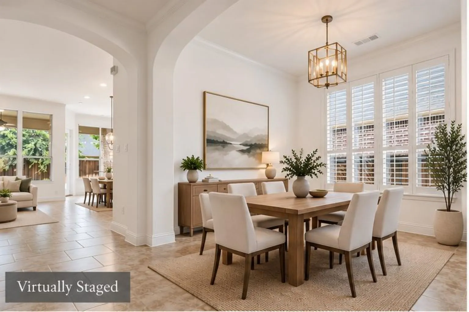 Arched entryway, tiled flooring, plantation shutters, and a chandelier with a rectangular frame