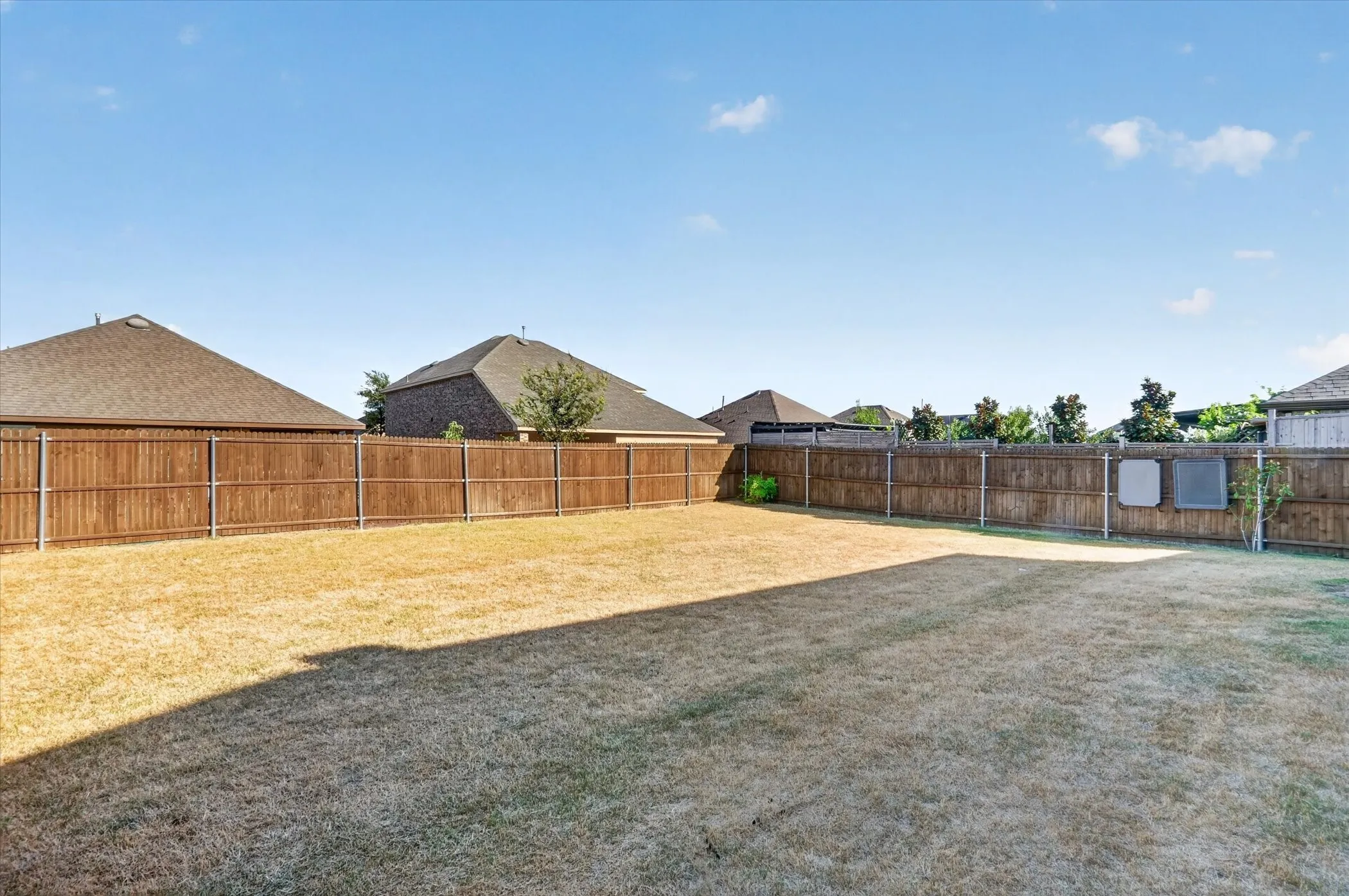 Expansive outdoor area with a wood privacy fence