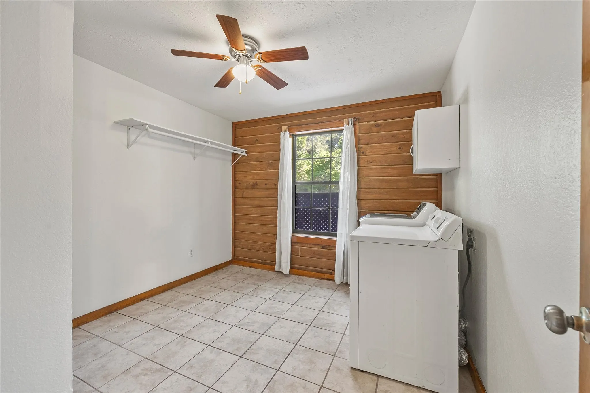 Oversized laundry room has closet and space for freezer, extra refrigerator, storage.