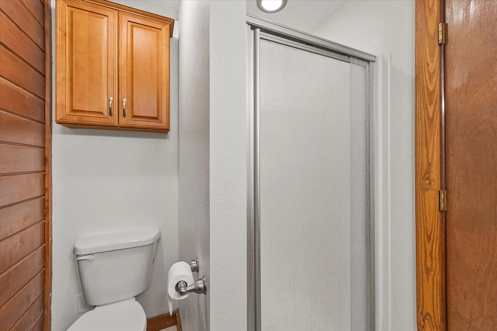 Primary bath has shower, accent wall and storage.