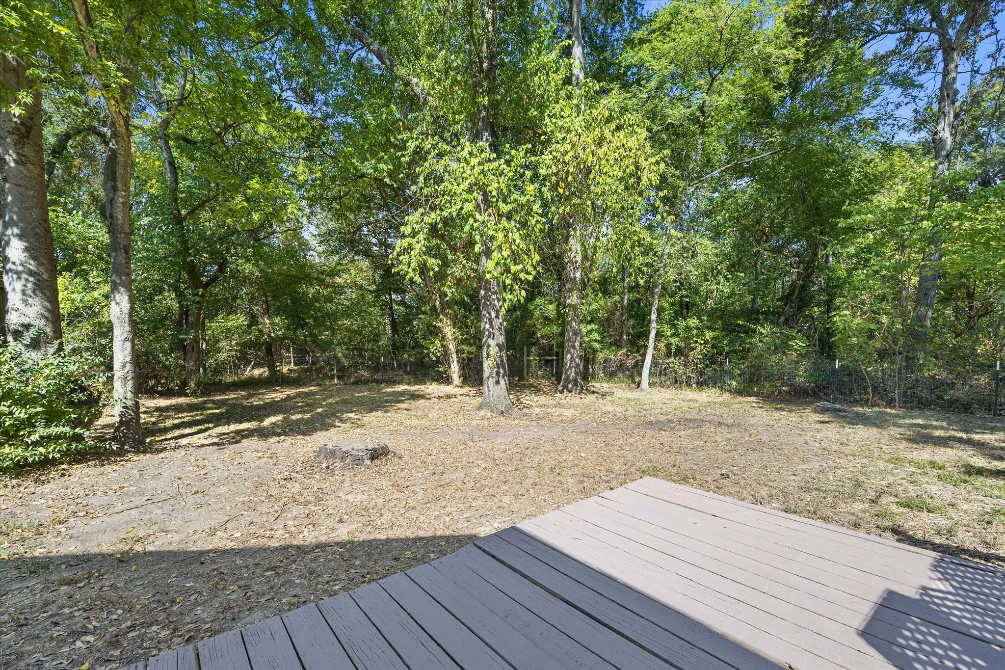 Back yard and lower level of wood deck.