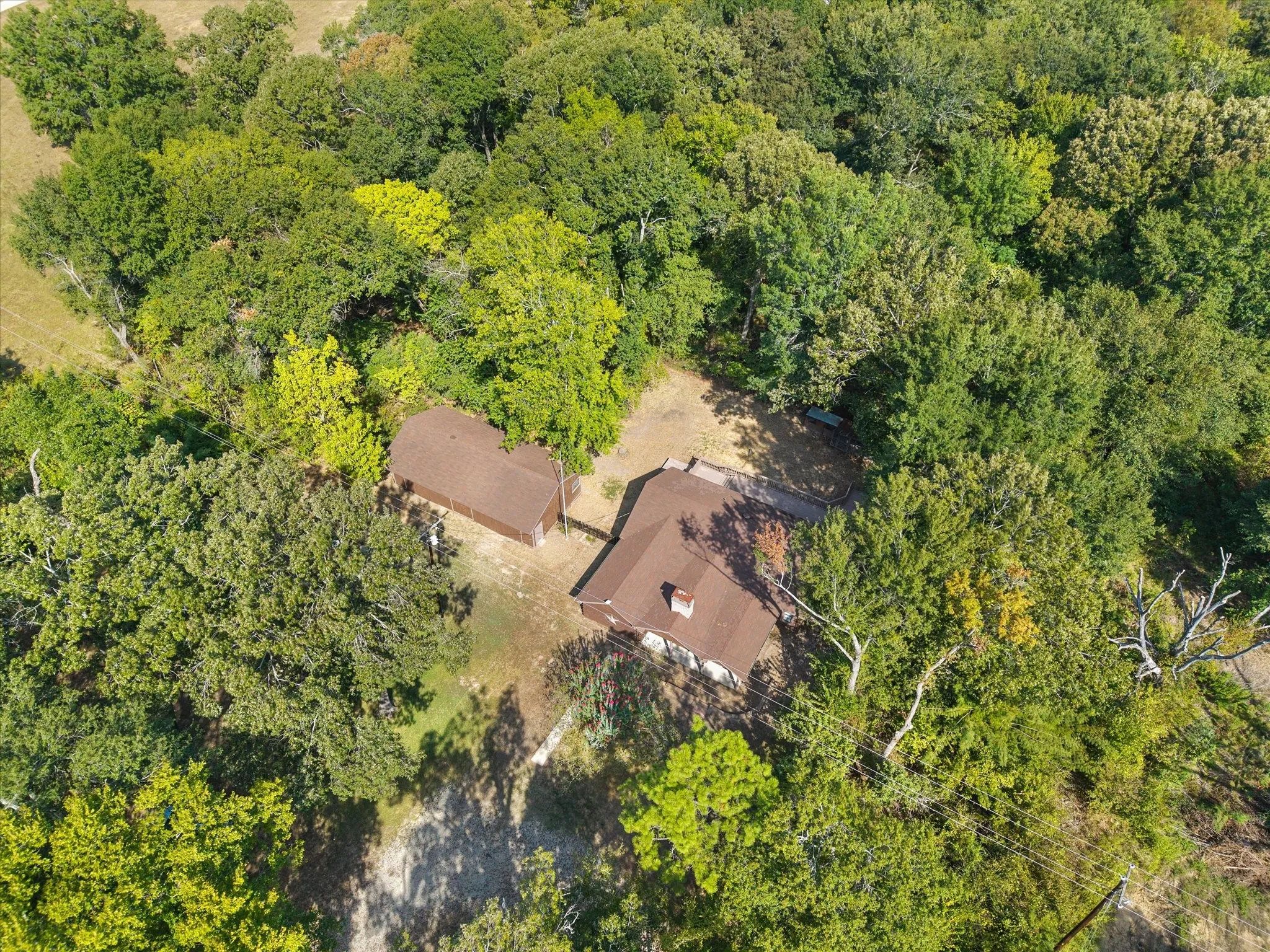Another overhead view of the one acre wooded lot and this beautiful 3/3 custom log home with four car garage and workshop.