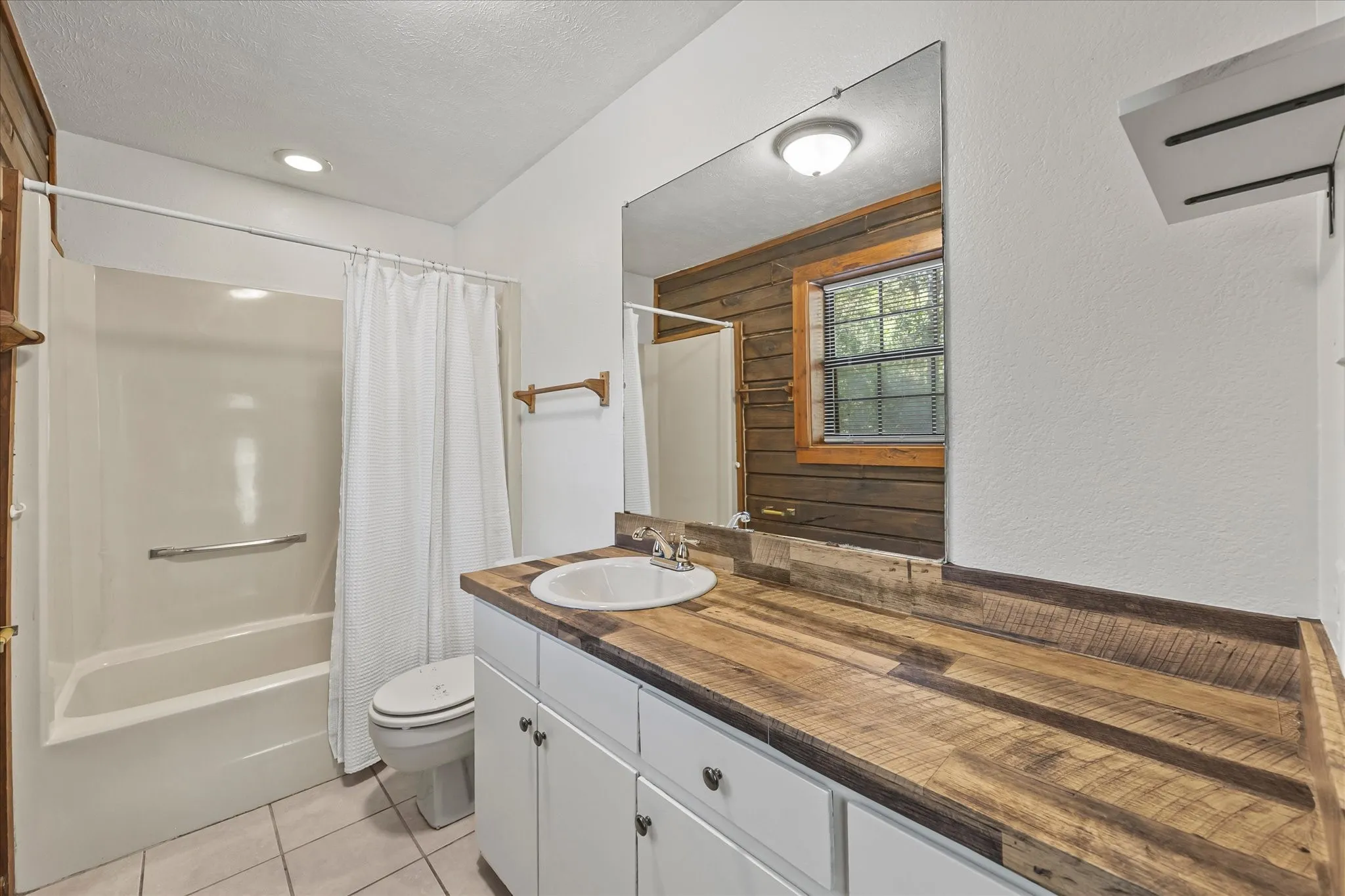 Ensuite bathroom 2 has tub-shower combo, lots of storage and counter space and tile floors.