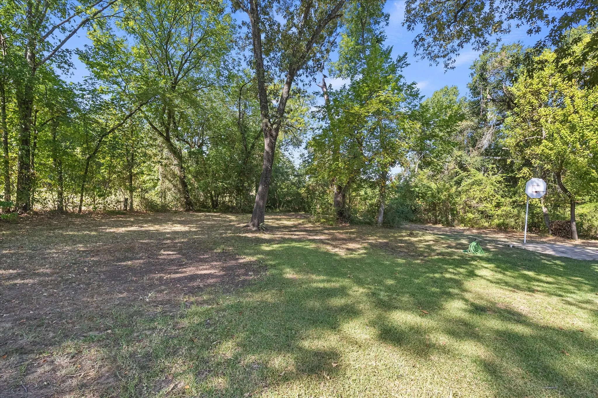 Part of the wooded one acre grounds with ample space to roam, relax or add a guest house, pool, or playground.