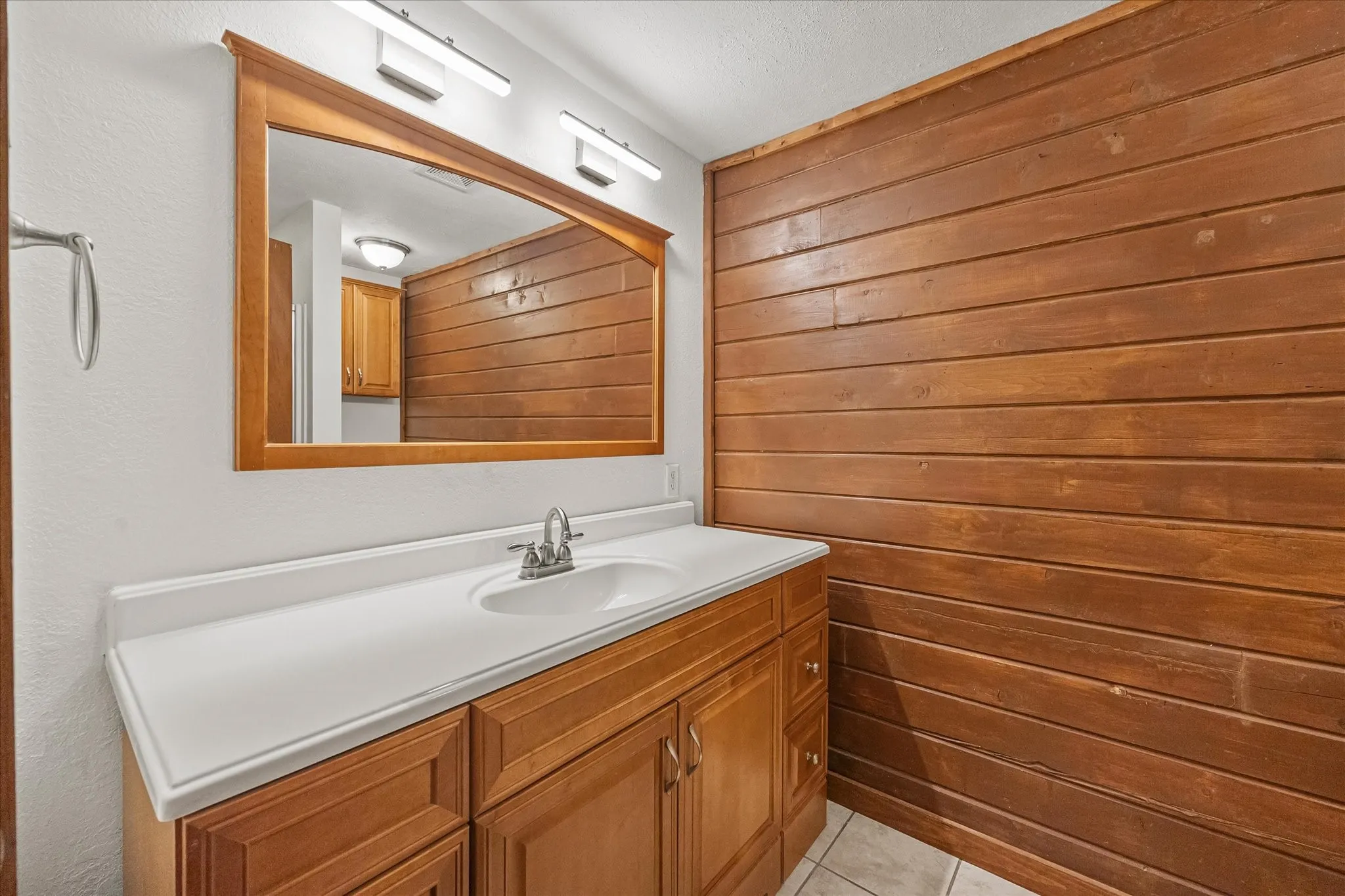 Ensuite primary bath with fresh paint and lighting.