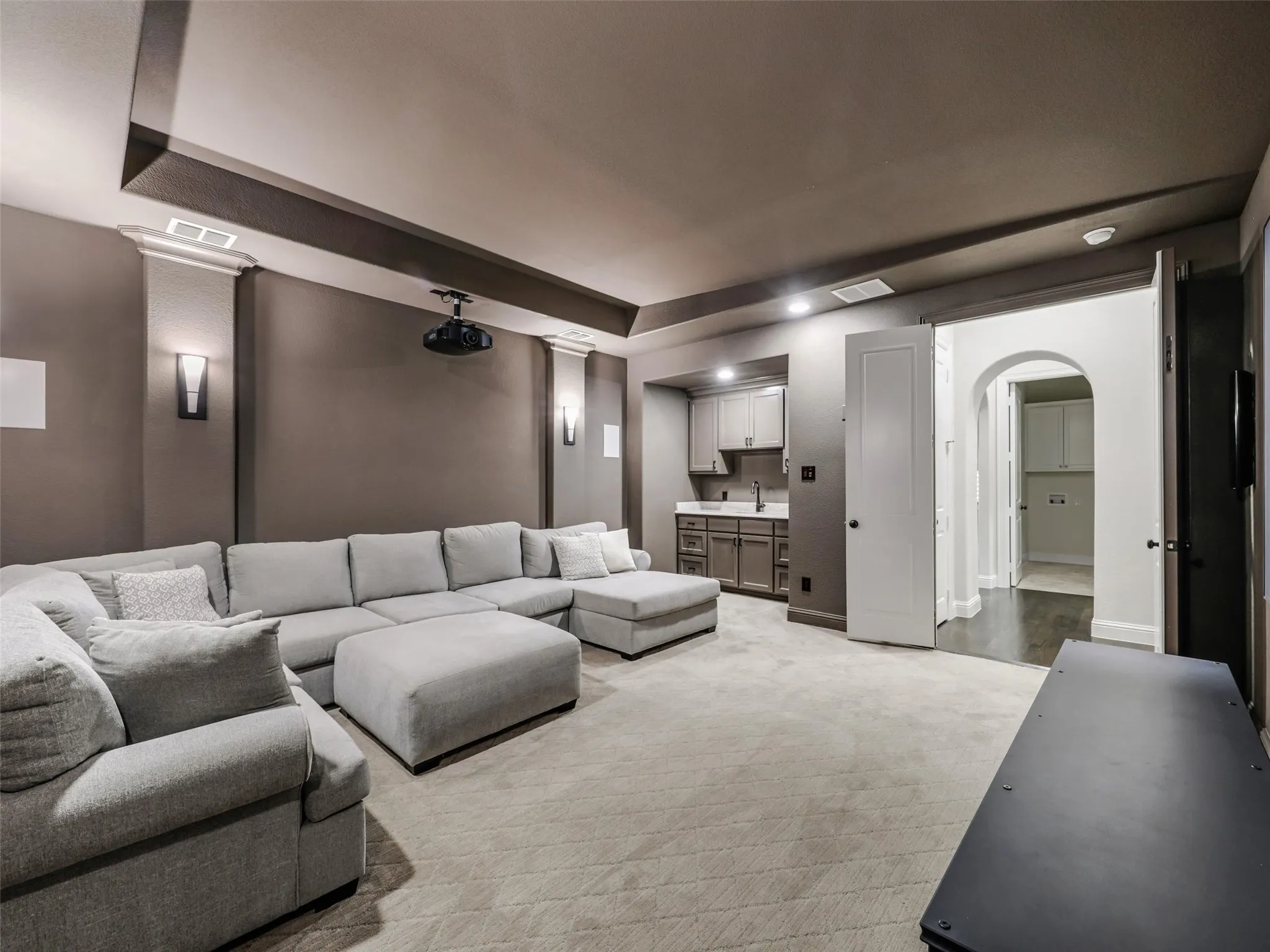 DOWN-STAIRS-MEDIA.  Majorly sought after floor plan.  GUEST and MEDIA DOWN.  Oversized GARAGE SPACES. The home's entertainment spaces continue with a dedicated media room featuring sconce lighting and a substantial 6-by-4-foot wet bar. Whether hosting movie nights, sporting events, or gatherings with friends, this flexible space provides another destination for entertaining without leaving home.