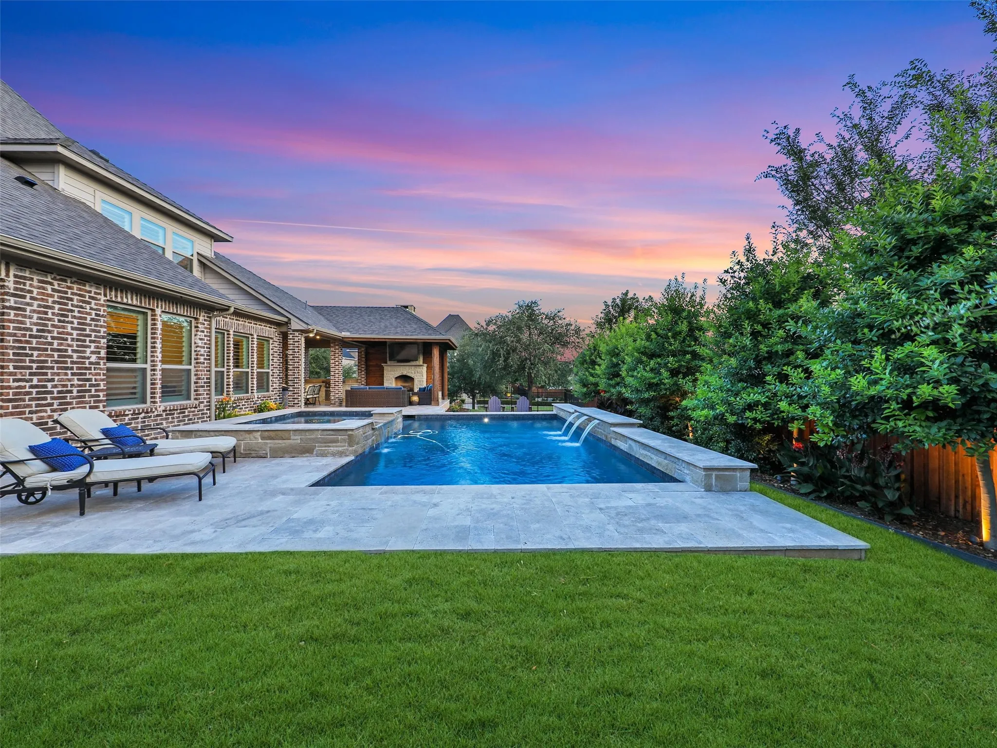 Outside, the property transforms into a private resort designed for year-round enjoyment. The Foley Pools swimming pool, completed in 2021, is complemented by an oversized spa with seating for approximately 10. Travertine limestone surrounds the pool and is used throughout the decking and coping, giving the outdoor environment a cohesive, upscale finish. Pentair pool equipment with wireless controls provides convenient operation, while individual pumps for the pool features allow greater flexibility and independent control.