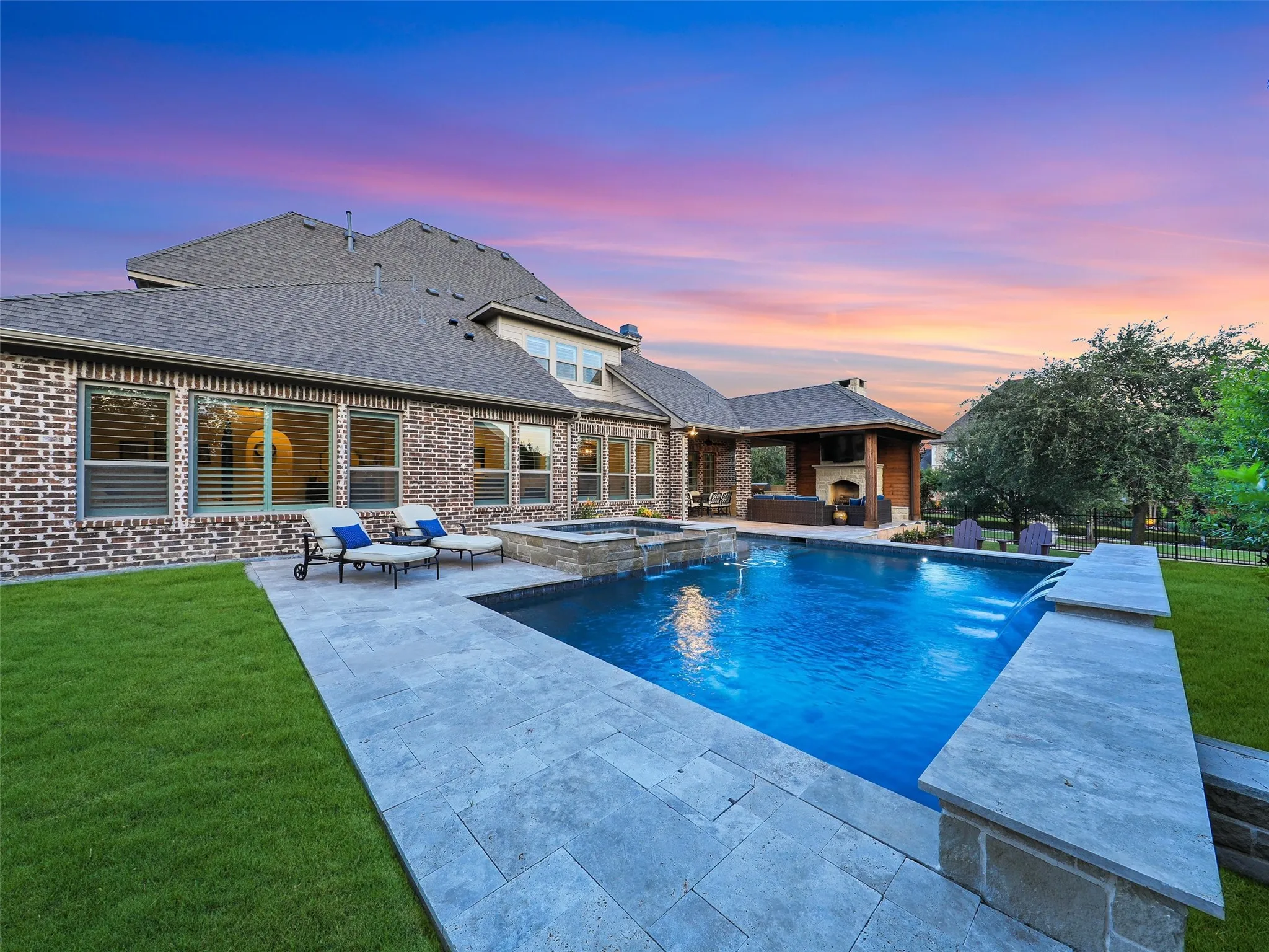 Outside, the property transforms into a private resort designed for year-round enjoyment. The Foley Pools swimming pool, completed in 2021, is complemented by an oversized spa with seating for approximately 10. Travertine limestone surrounds the pool and is used throughout the decking and coping, giving the outdoor environment a cohesive, upscale finish. Pentair pool equipment with wireless controls provides convenient operation, while individual pumps for the pool features allow greater flexibility and independent control.