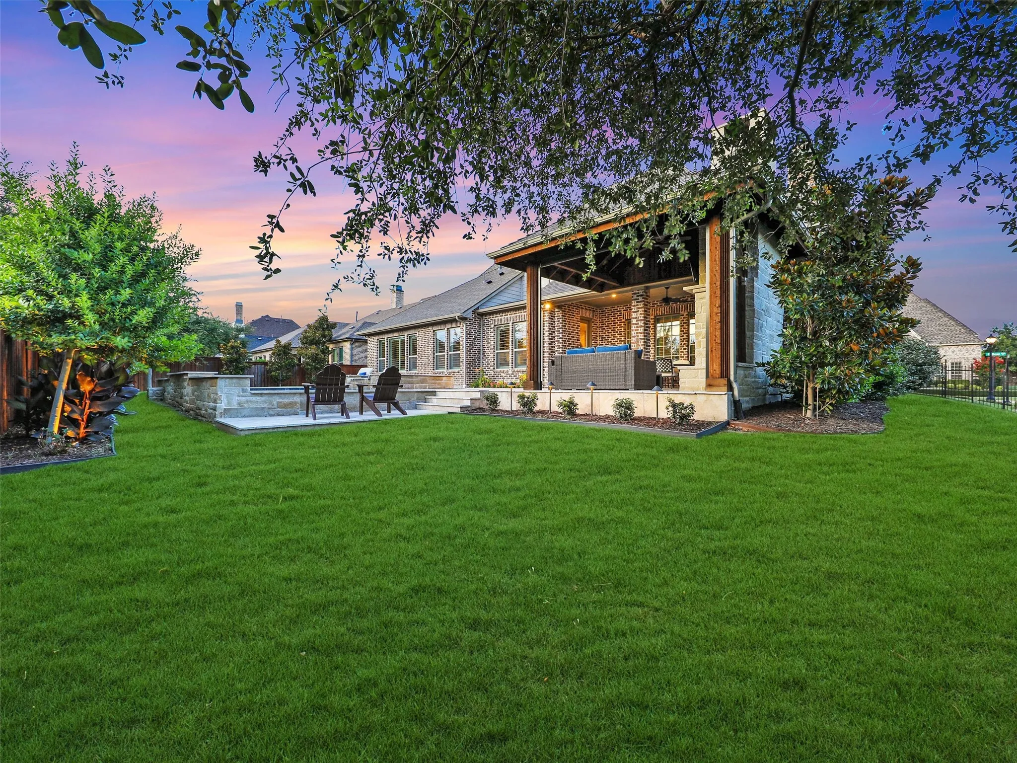 HUGE OPEN YARD SPACES. GREAT for play, pets, and family entertaining. The landscaping has also been thoughtfully enhanced with mature plantings, including five holly trees, five magnolia trees, and a mature oak tree. A wrought iron fence, refinished in 2024, complements the grounds and outdoor living environment.