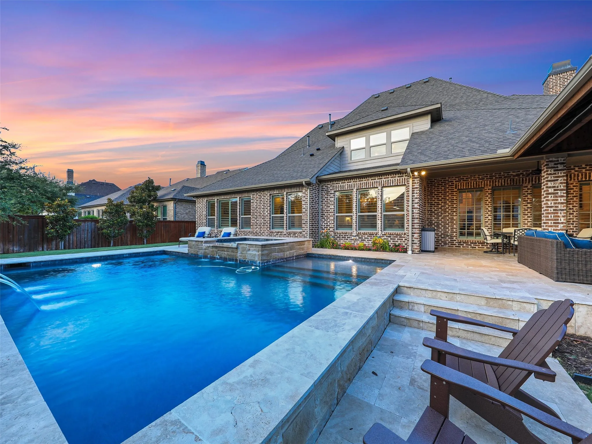 Outside, the property transforms into a private resort designed for year-round enjoyment. The Foley Pools swimming pool, completed in 2021, is complemented by an oversized spa with seating for approximately 10. Travertine limestone surrounds the pool and is used throughout the decking and coping, giving the outdoor environment a cohesive, upscale finish. Pentair pool equipment with wireless controls provides convenient operation, while individual pumps for the pool features allow greater flexibility and independent control.