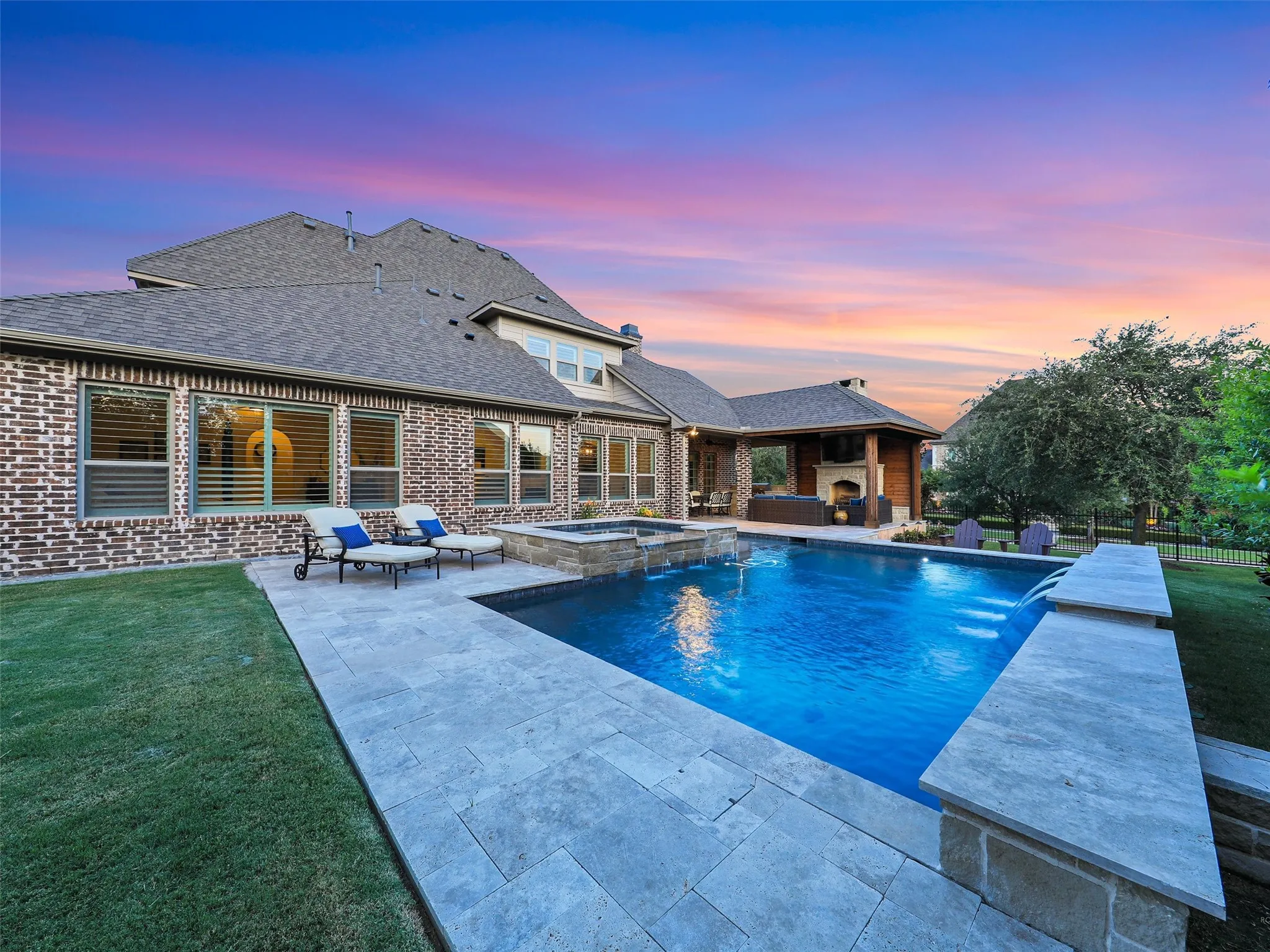 Outside, the property transforms into a private resort designed for year-round enjoyment. The Foley Pools swimming pool, completed in 2021, is complemented by an oversized spa with seating for approximately 10. Travertine limestone surrounds the pool and is used throughout the decking and coping, giving the outdoor environment a cohesive, upscale finish. Pentair pool equipment with wireless controls provides convenient operation, while individual pumps for the pool features allow greater flexibility and independent control.