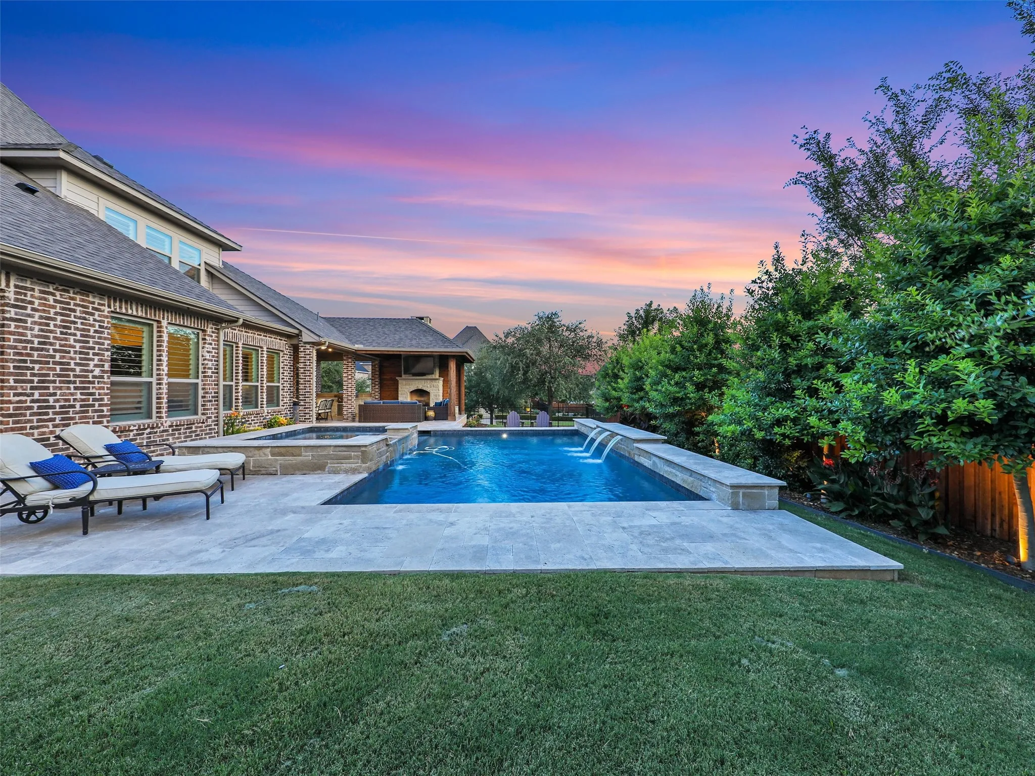 HUGE OPEN YARD SPACE.  Outside, the property transforms into a private resort designed for year-round enjoyment. The Foley Pools swimming pool, completed in 2021, is complemented by an oversized spa with seating for approximately 10. Travertine limestone surrounds the pool and is used throughout the decking and coping, giving the outdoor environment a cohesive, upscale finish. Pentair pool equipment with wireless controls provides convenient operation, while individual pumps for the pool features allow greater flexibility and independent control.