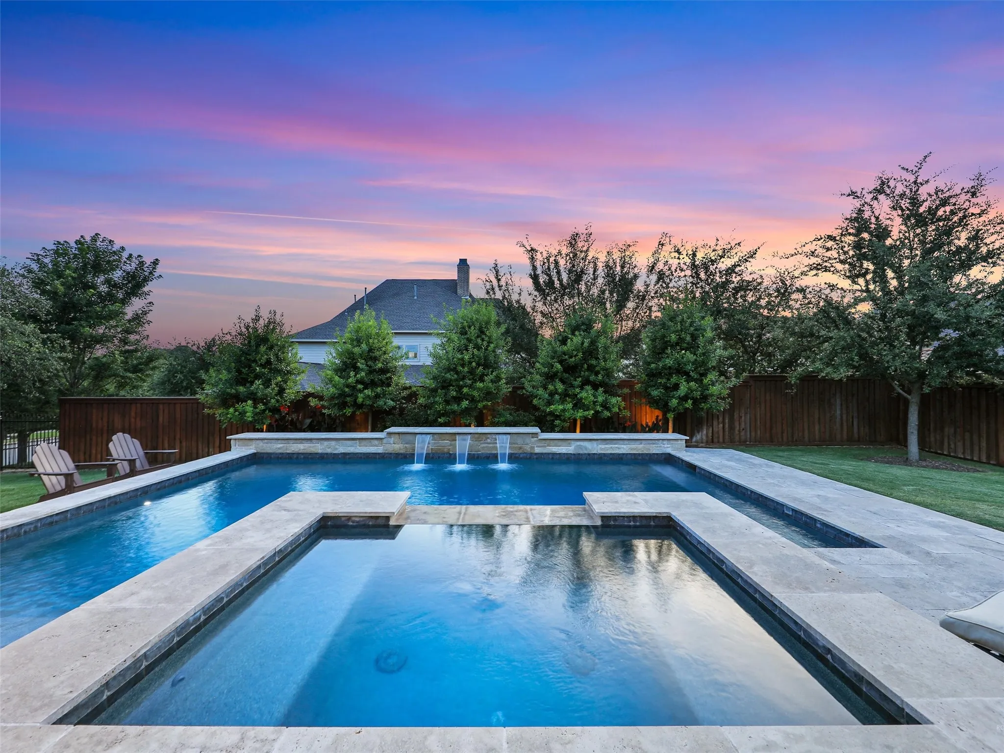 Outside, the property transforms into a private resort designed for year-round enjoyment. The Foley Pools swimming pool, completed in 2021, is complemented by an oversized spa with seating for approximately 10. Travertine limestone surrounds the pool and is used throughout the decking and coping, giving the outdoor environment a cohesive, upscale finish. Pentair pool equipment with wireless controls provides convenient operation, while individual pumps for the pool features allow greater flexibility and independent control.