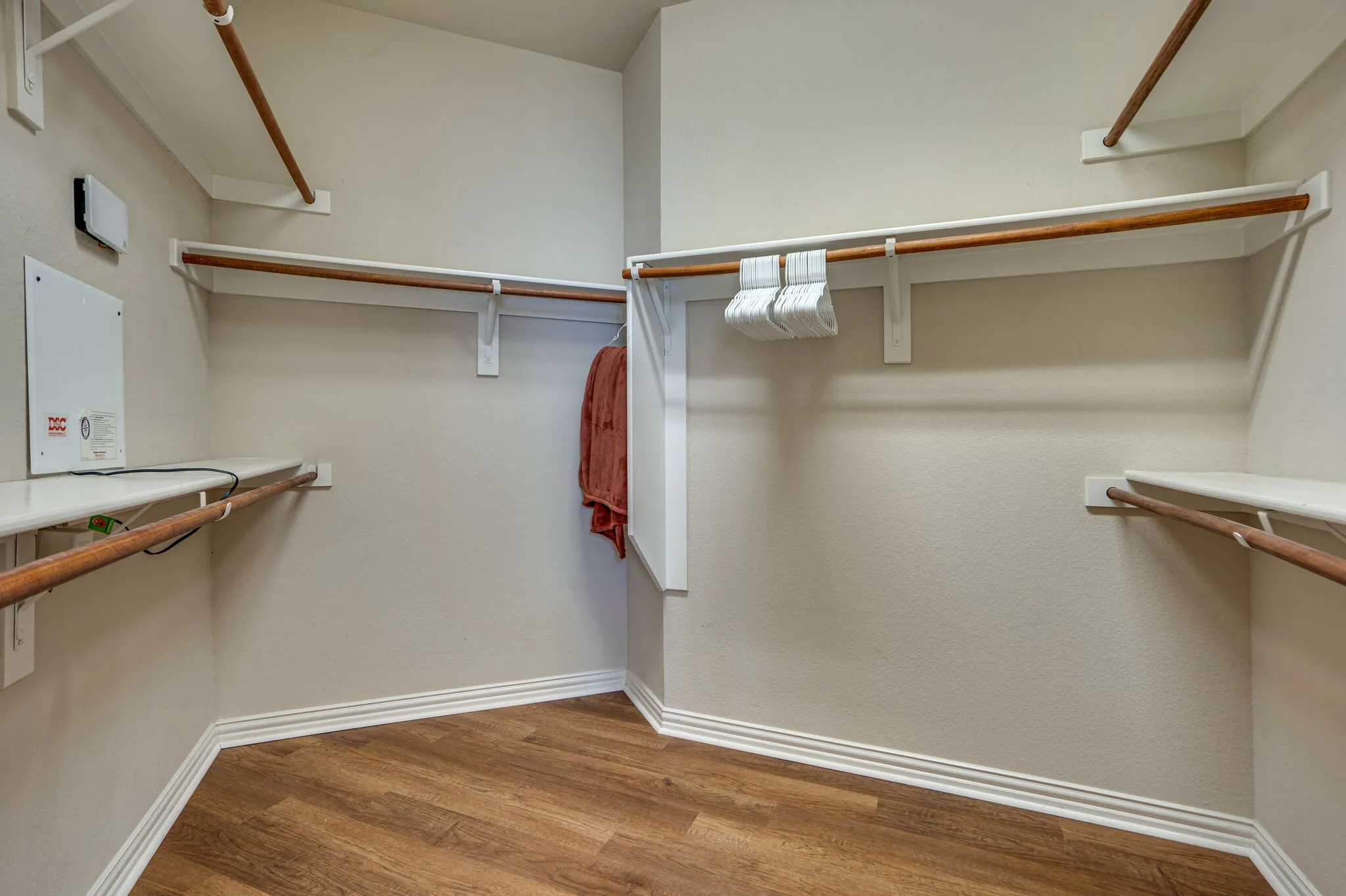 Wood-finish flooring with white baseboards