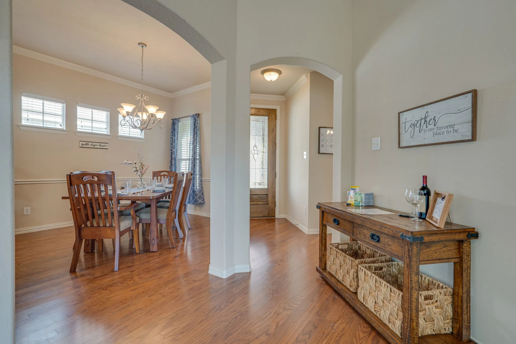 Hardwood-finish flooring throughout, framed by arched doorways
