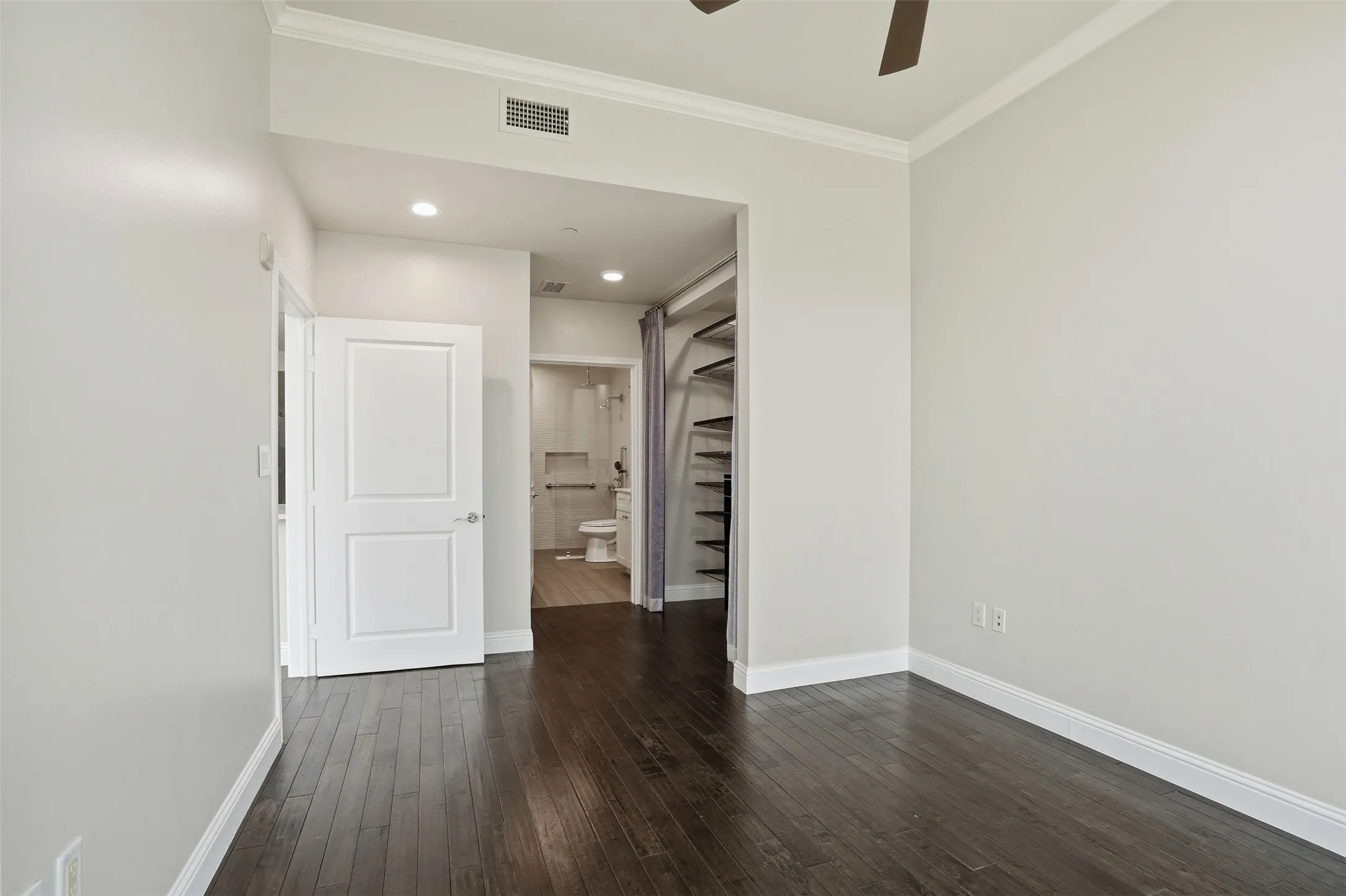 Dark wood-finish flooring with white baseboards