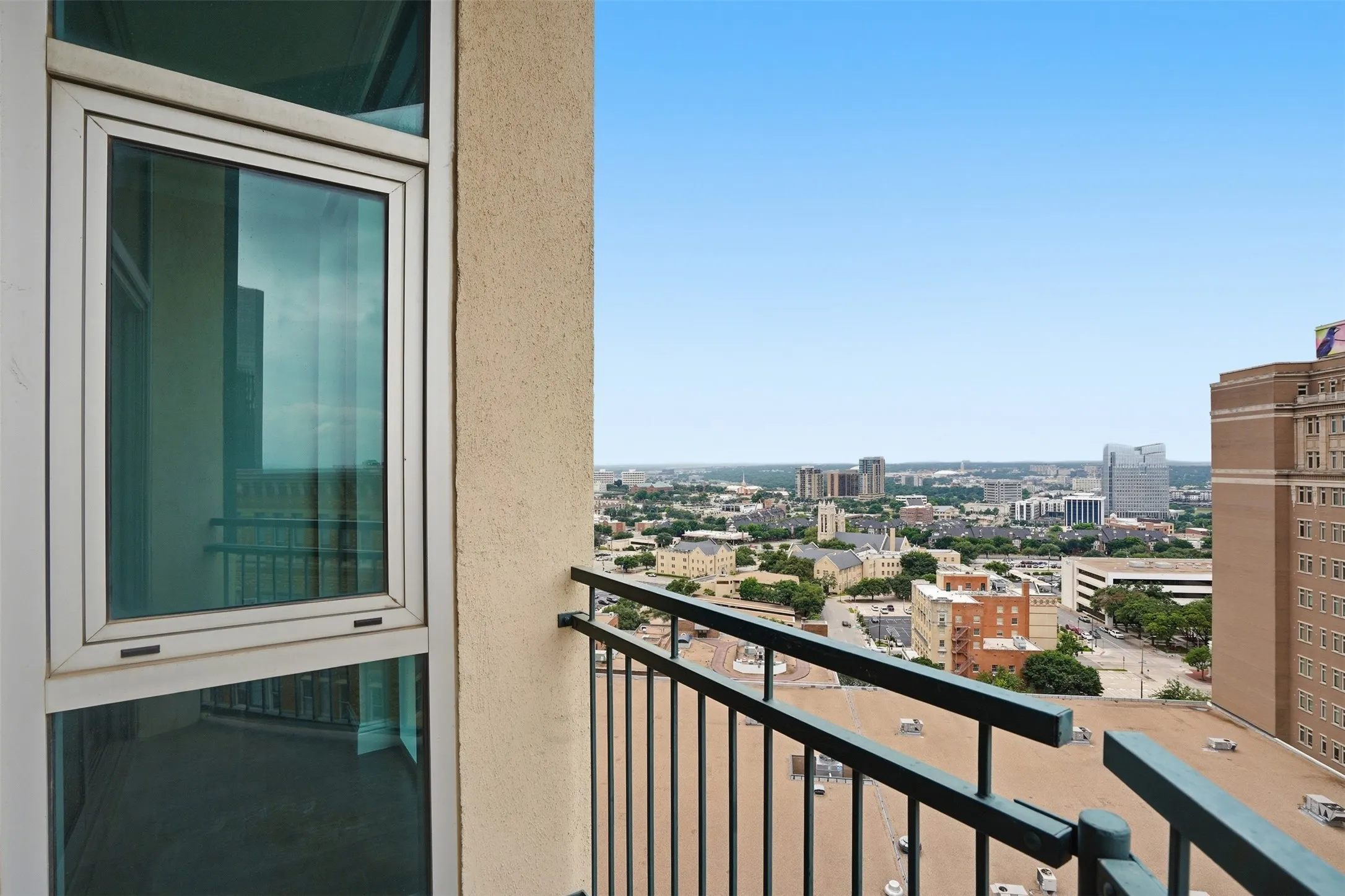 Balcony with metal railings, offering an urban skyline