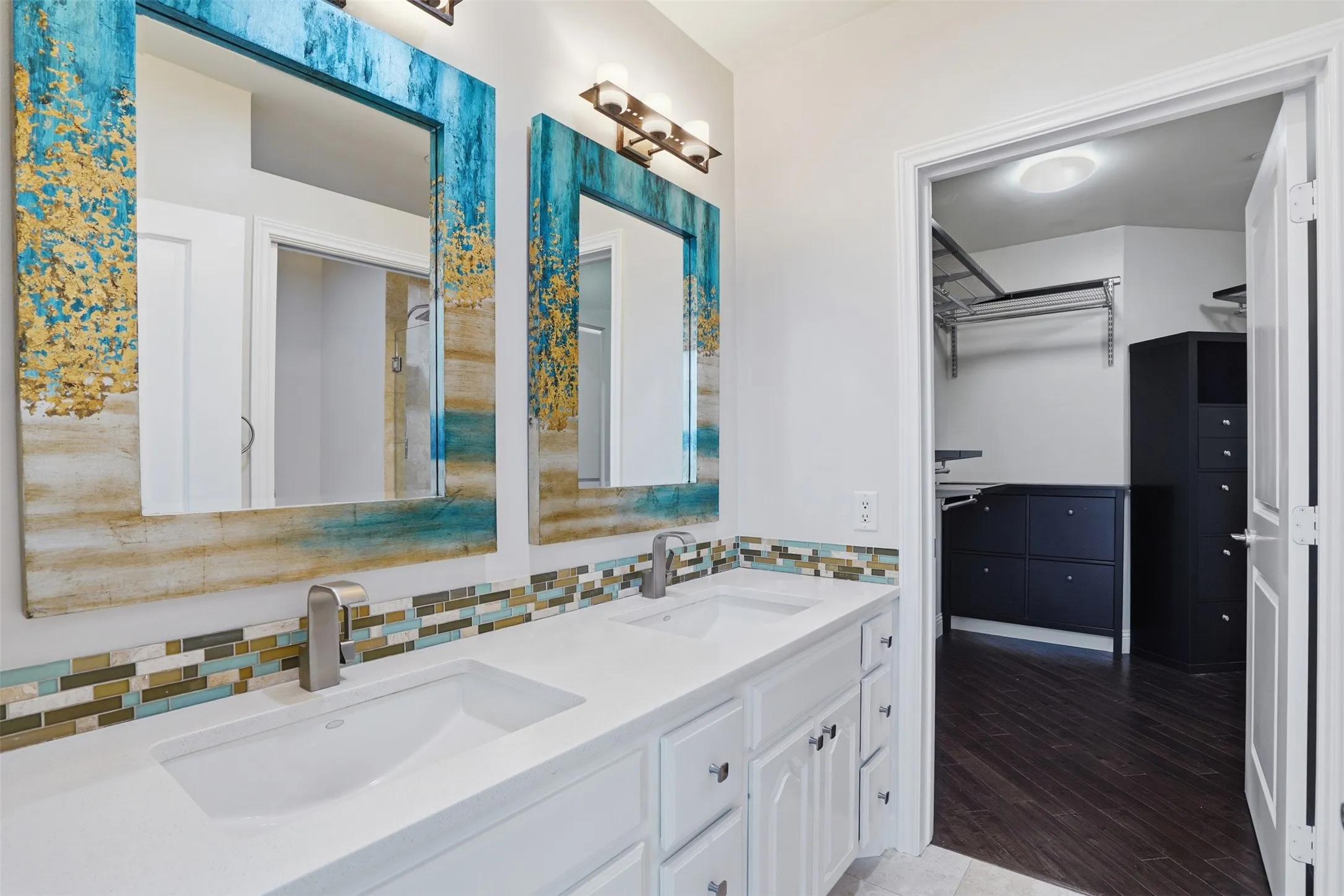 Dual vanity with undermount sinks, stone countertops, and brushed nickel fixtures