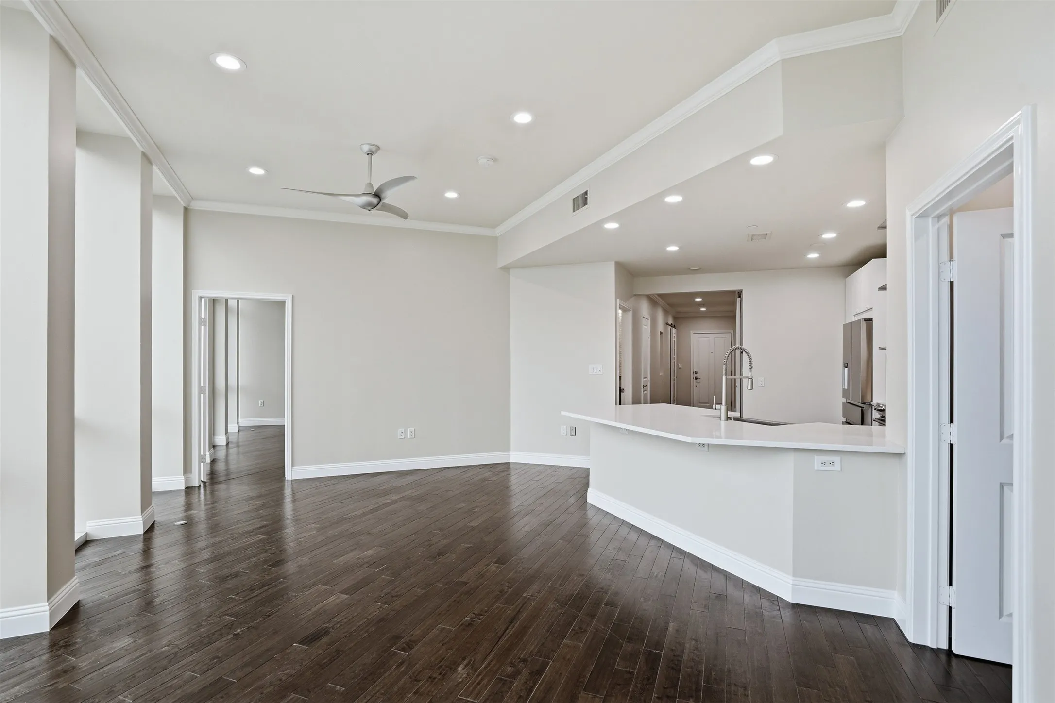 Dark wood-finish flooring with recessed lighting