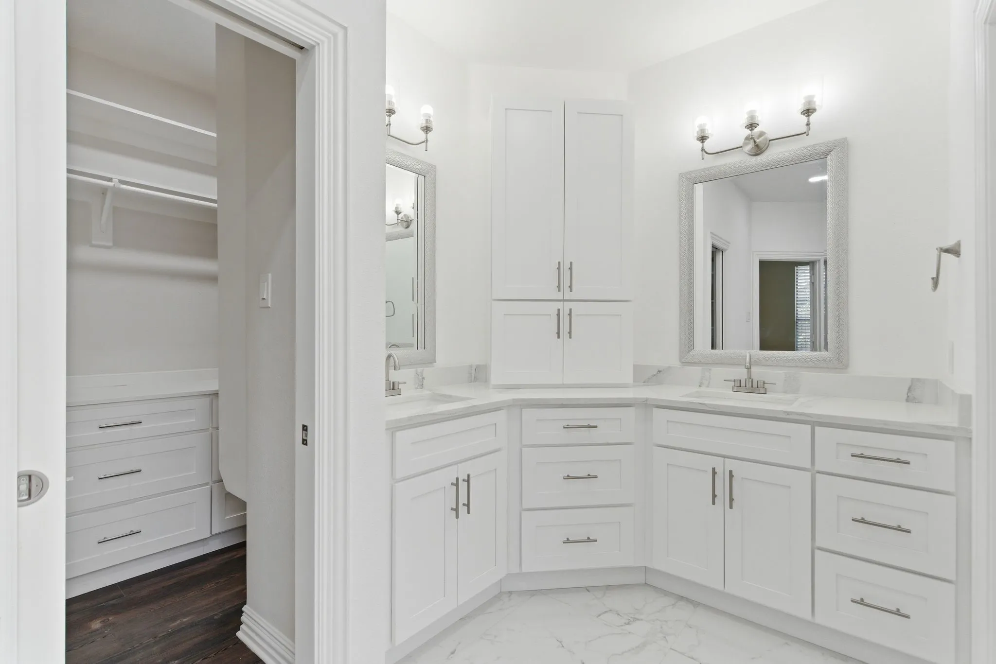 Dual vanity with white cabinetry and integrated sinks