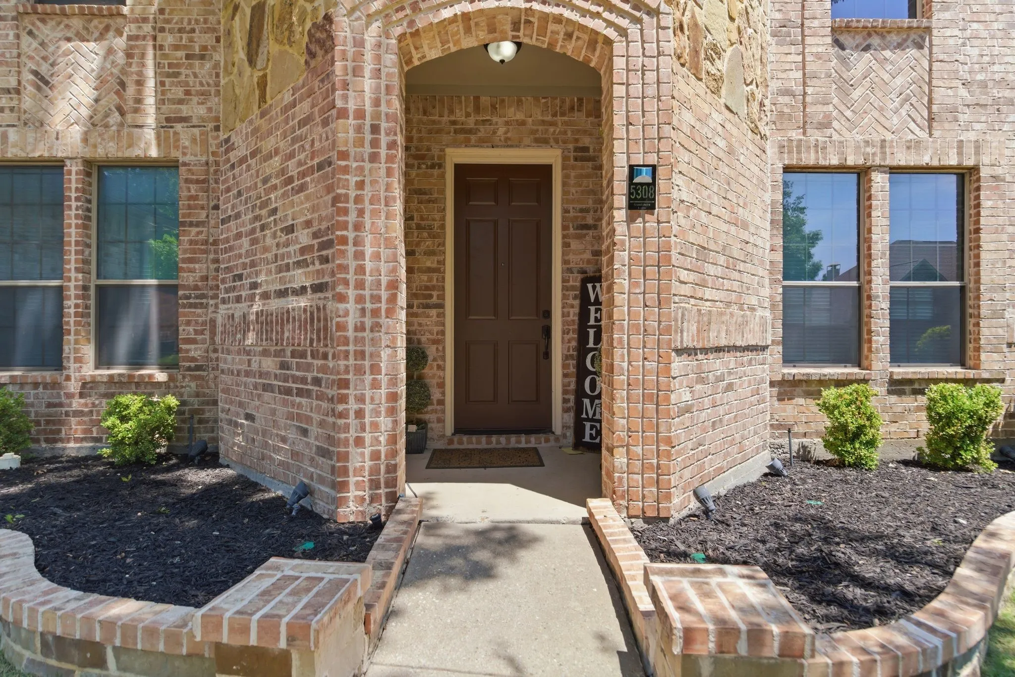 Brick and stone exterior with arched entryway