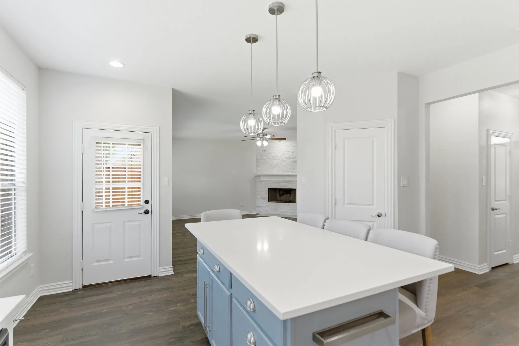 Kitchen island with a white countertop and blue cabinetry