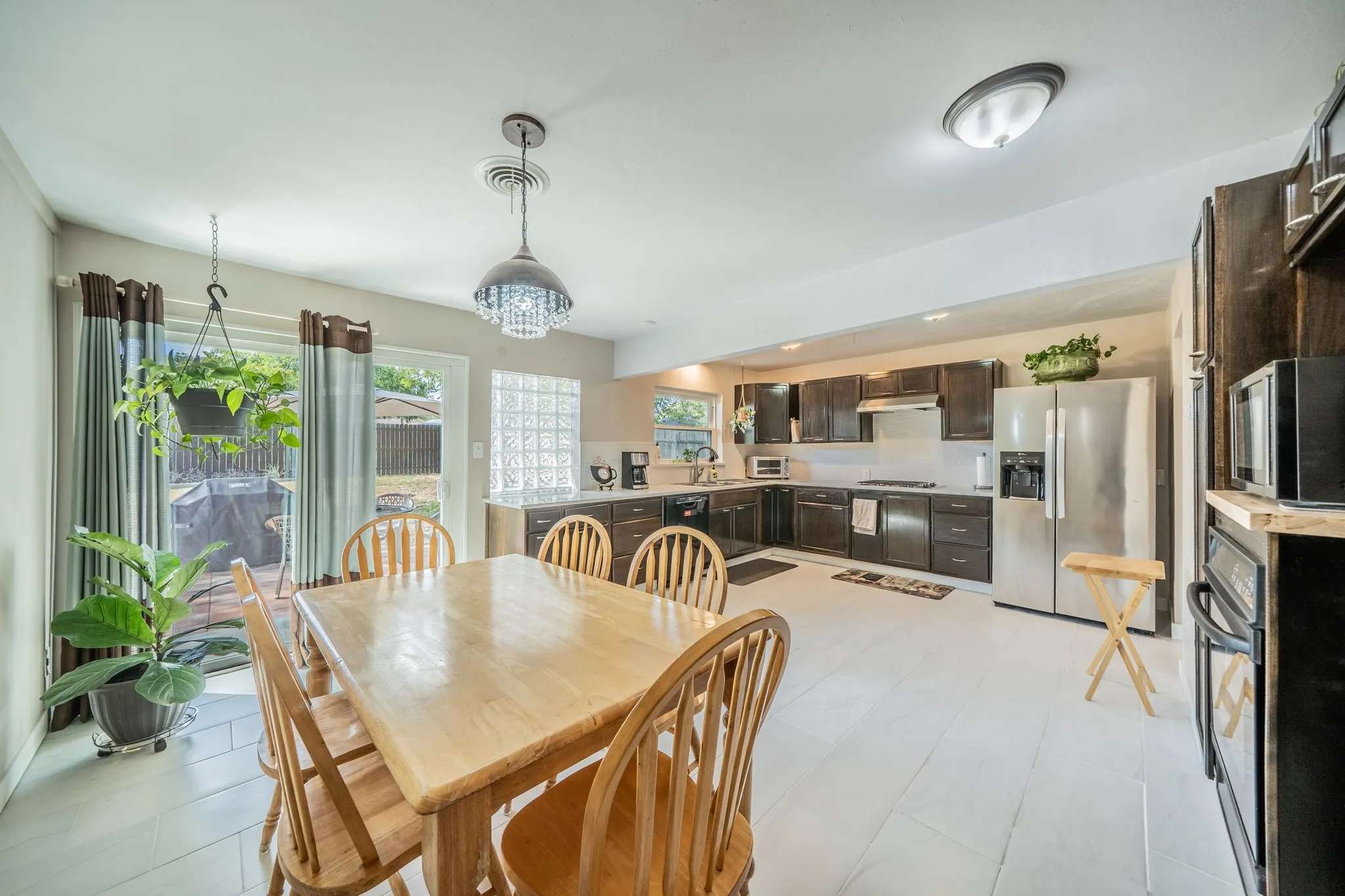  stainless steel appliances, and white oversized c-tile flooring